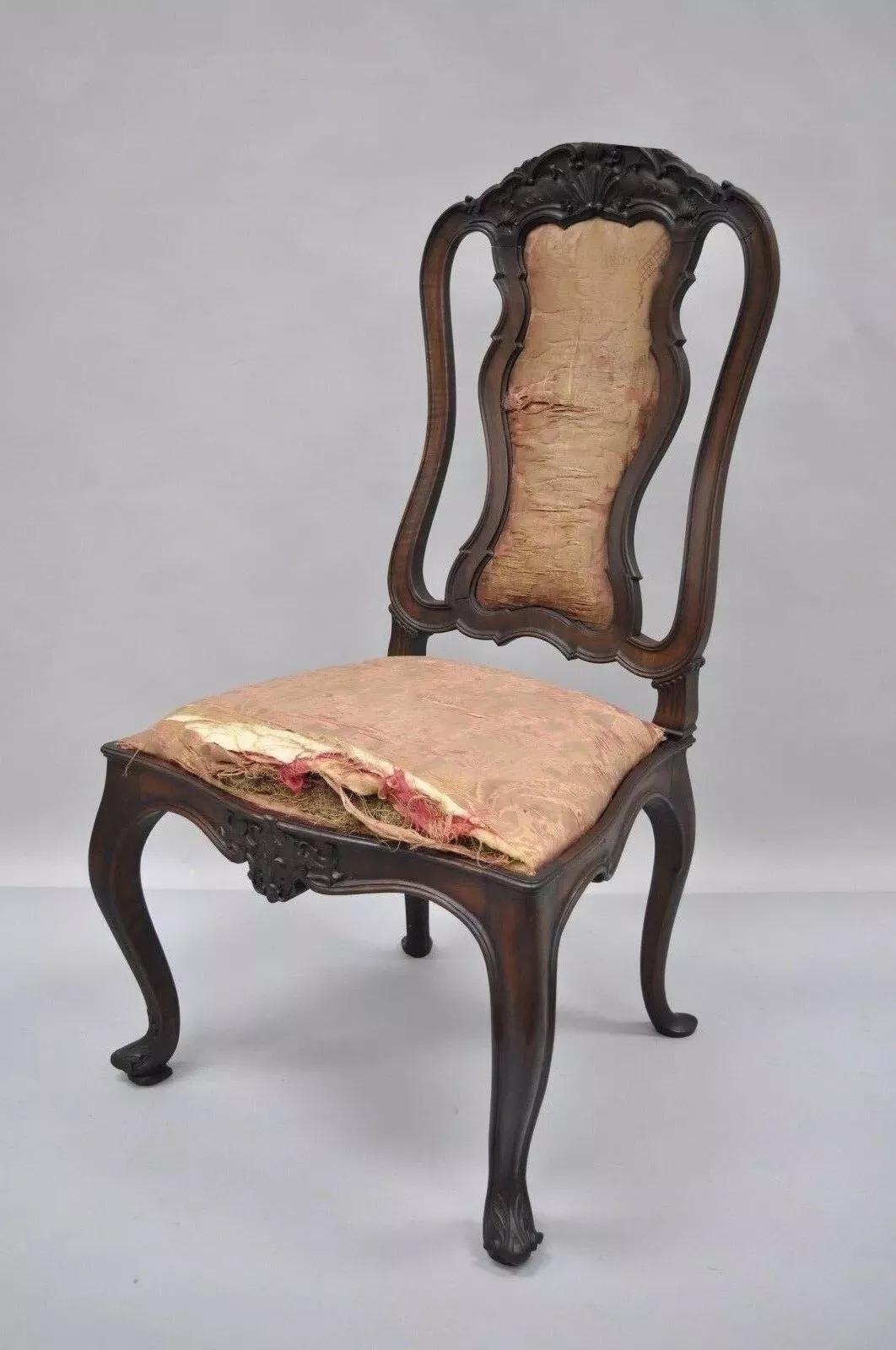Antique Italian Baroque Carved Walnut Dining Chair. Item features solid carved walnut frame, finely carved top rail and lower rail, unique wooden rear backrest, shapely upholstered back, cabriole legs with carved feet, drop seats, and very