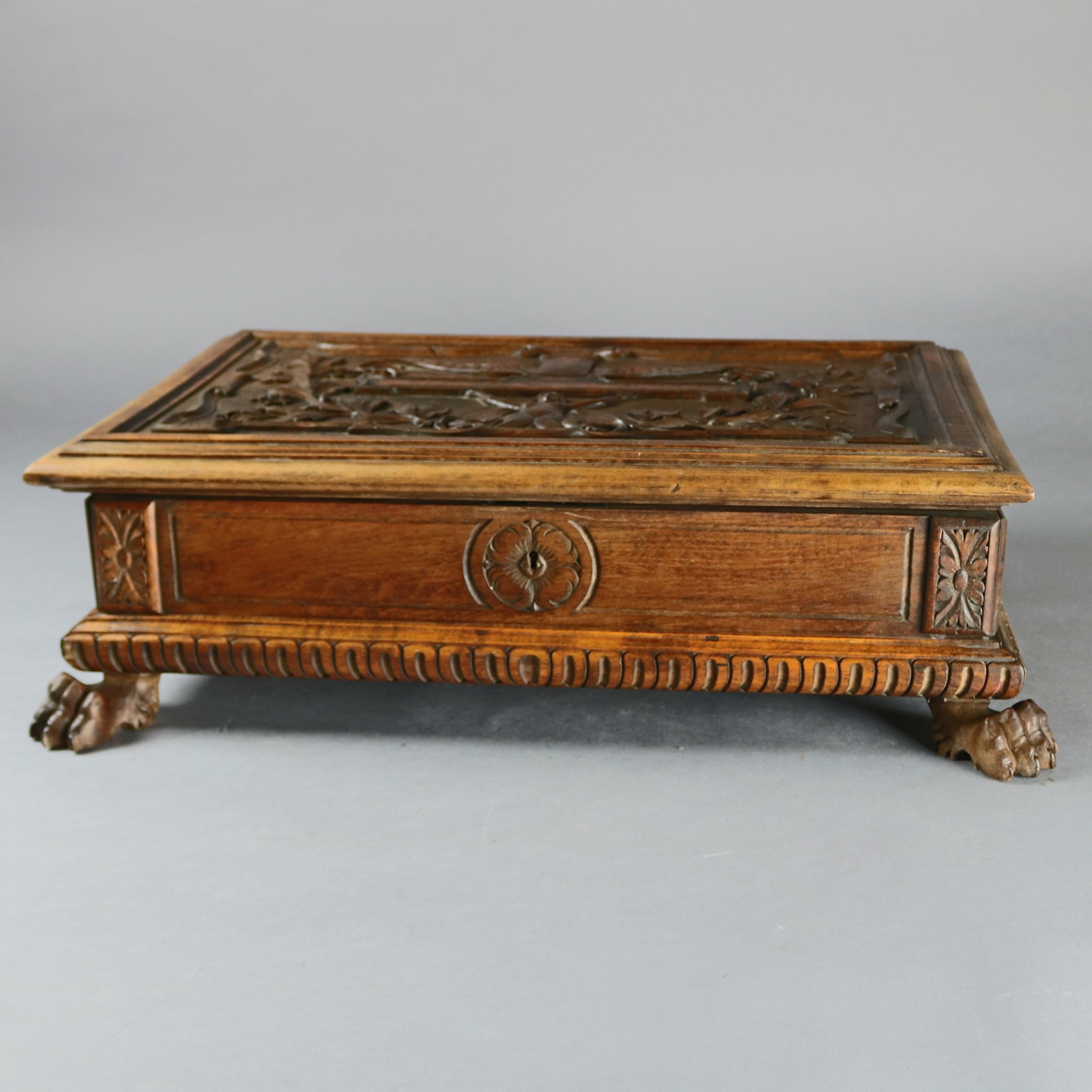 An antique figural bible box offers heavily carved walnut construction having top with 