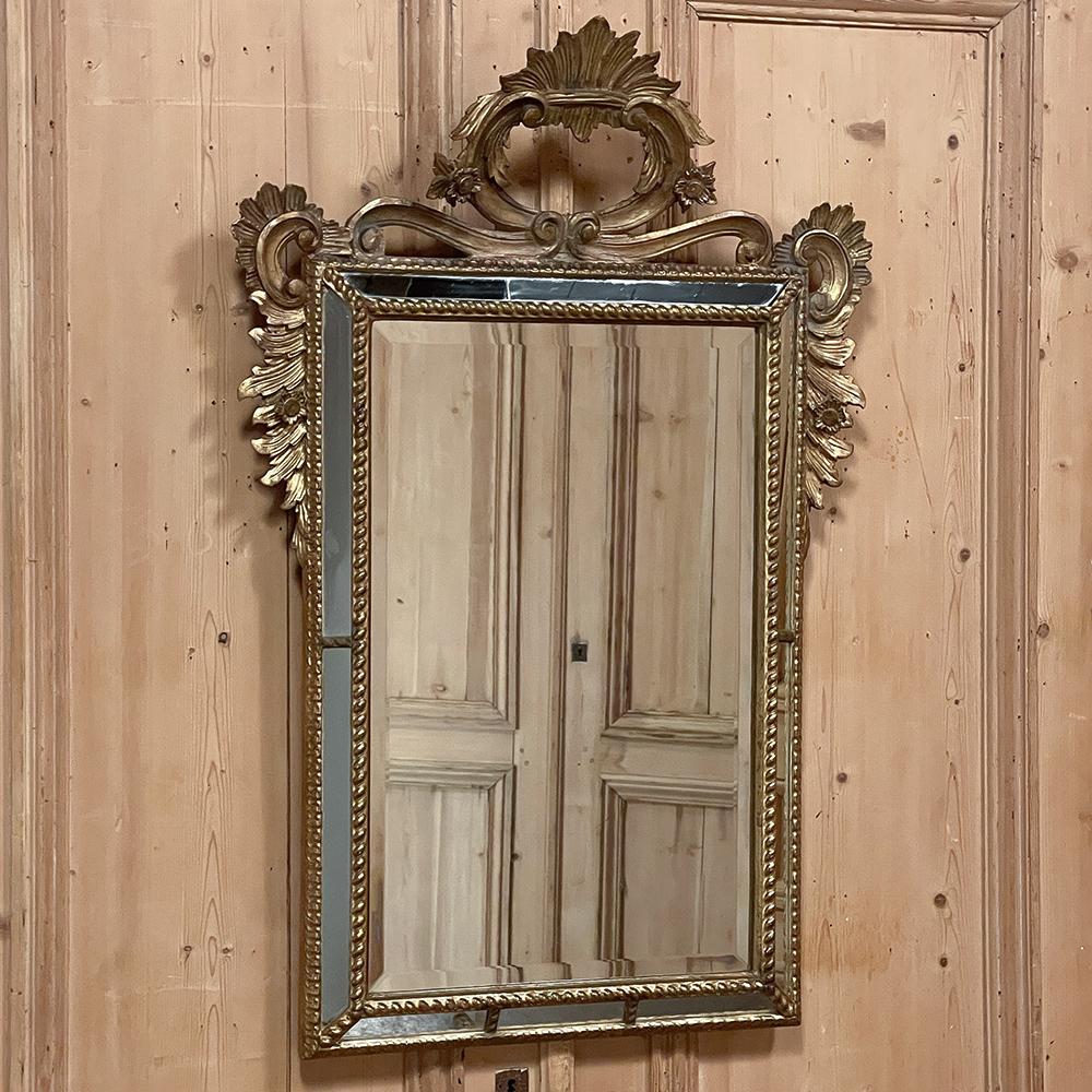 Antique Italian Baroque Giltwood mirror is a work of the sculptor's art that also happens to be a mirror! The main mirror is beveled and newly silvered to provide decades of enjoyment, and is surrounded by a spiral rope trim which projects out into