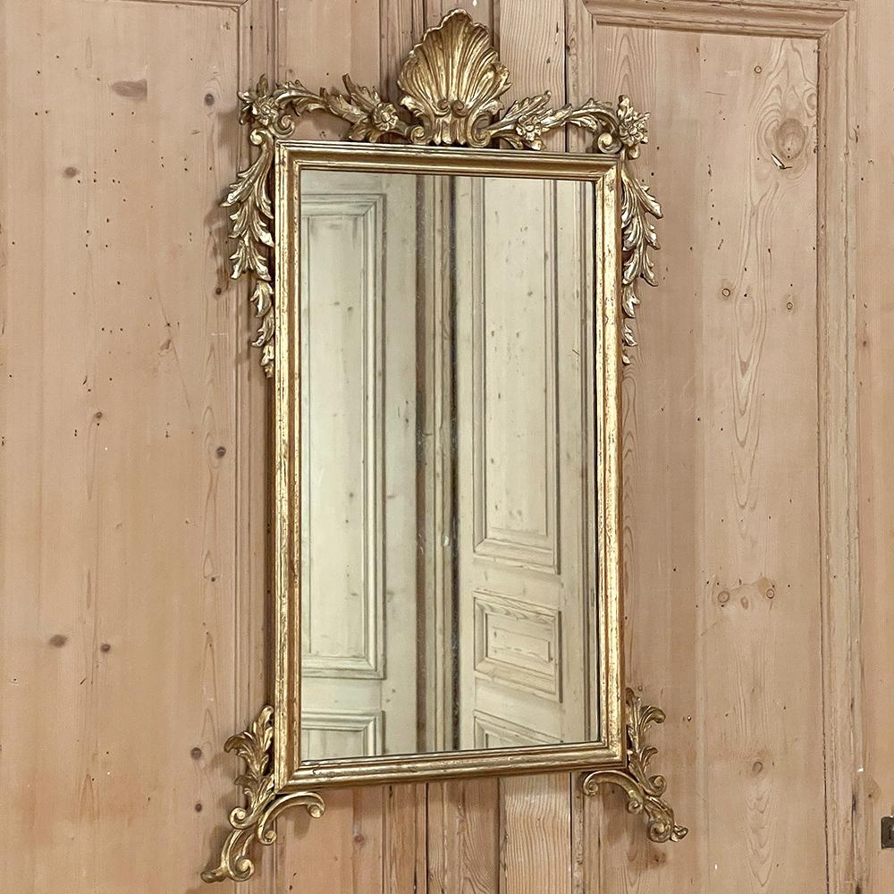Antique Italian Baroque Giltwood Mirror is the perfect blend of classical Italian sensibility melded with a touch of Baroque flair to create visual interest in any room!  A bold scallop shell takes center stage on the top, flanked by foliates with a