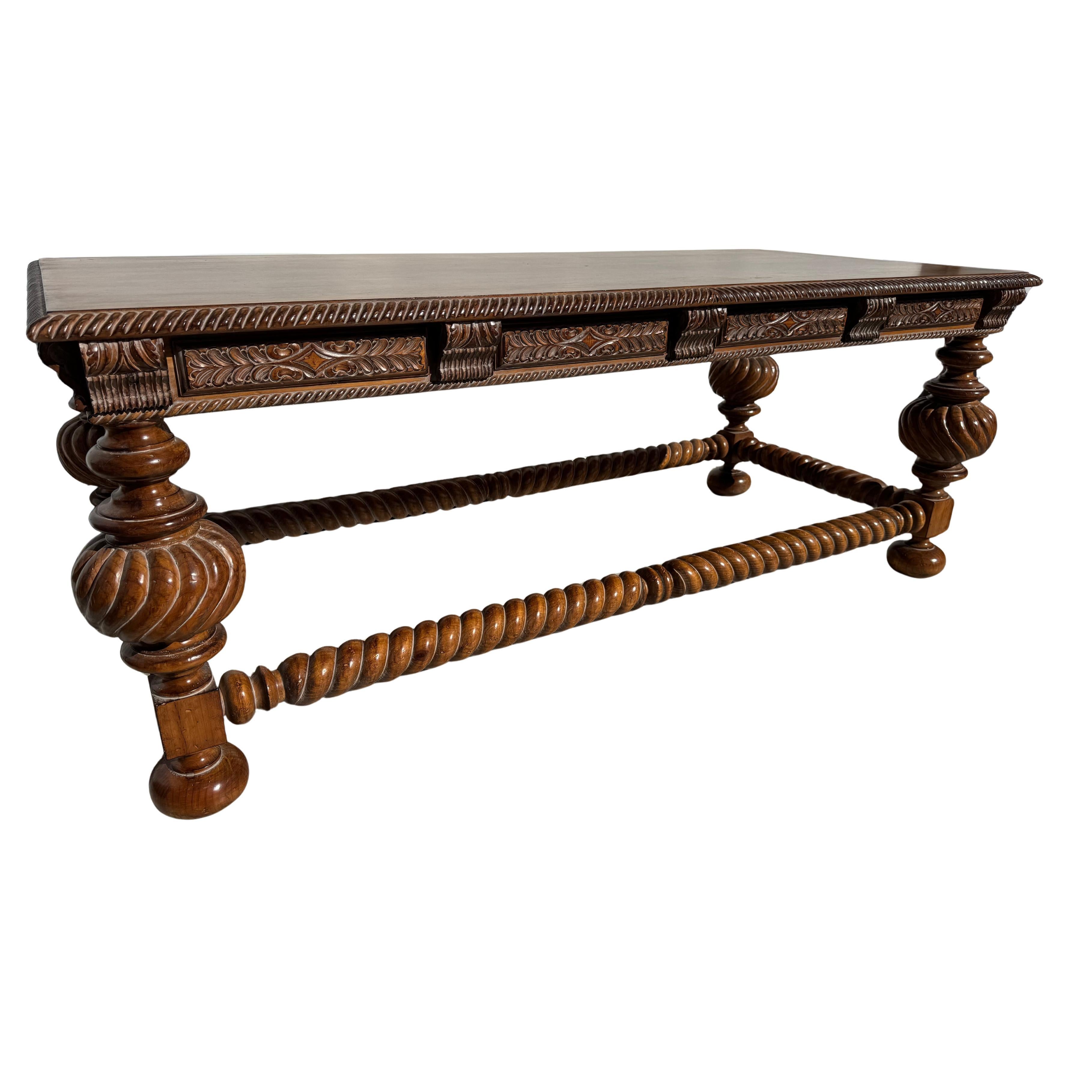 This is a high quality writing table.
Its crafted from solid walnut.
The legs showcase the baroque style with the bulbous knees.
The stretchers are crafted in the Barley Twist style.
The skirt of the table is highly carved showcasing Italian motifs