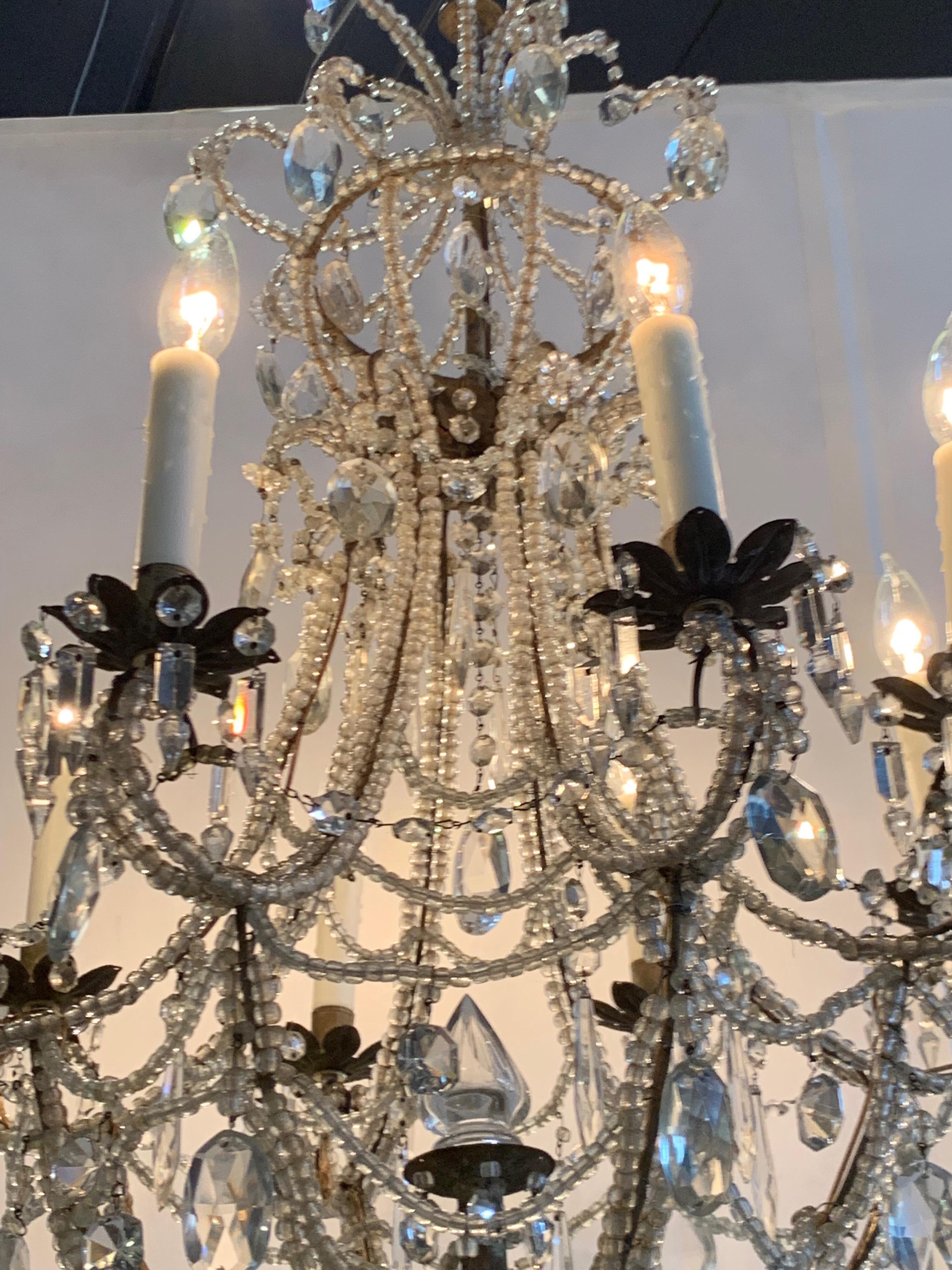 Elegant antique Italian beaded crystal chandelier. The fixture has 8 lights and sparkles with an abundance of beads, crystals and prisms. Just cleaned and re-wired and ready to hang. Matching chain and canopy included. Makes a beautiful statement!