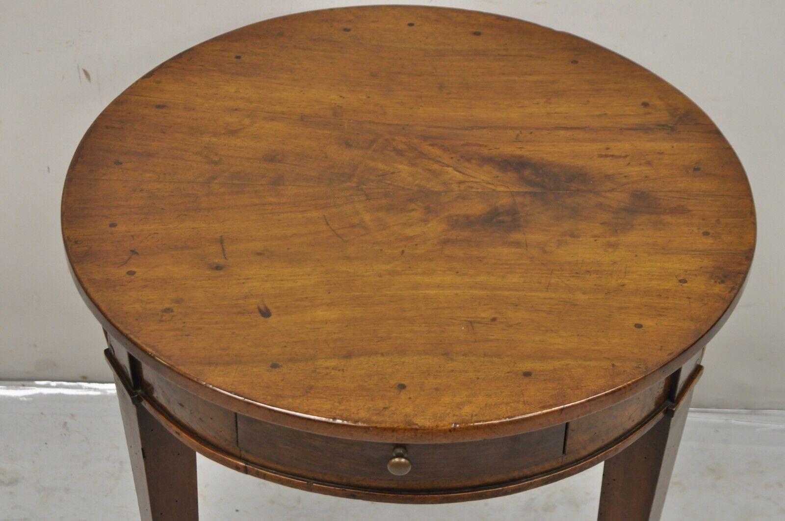Antique 19th Century Italian Biedermeier Country Provincial Cherry Wood Single Drawer Round Accent Table. Item features a single dovetailed drawer, solid cherry wood construction, original antiqued/distressed finish, tripod tapered legs, very nice