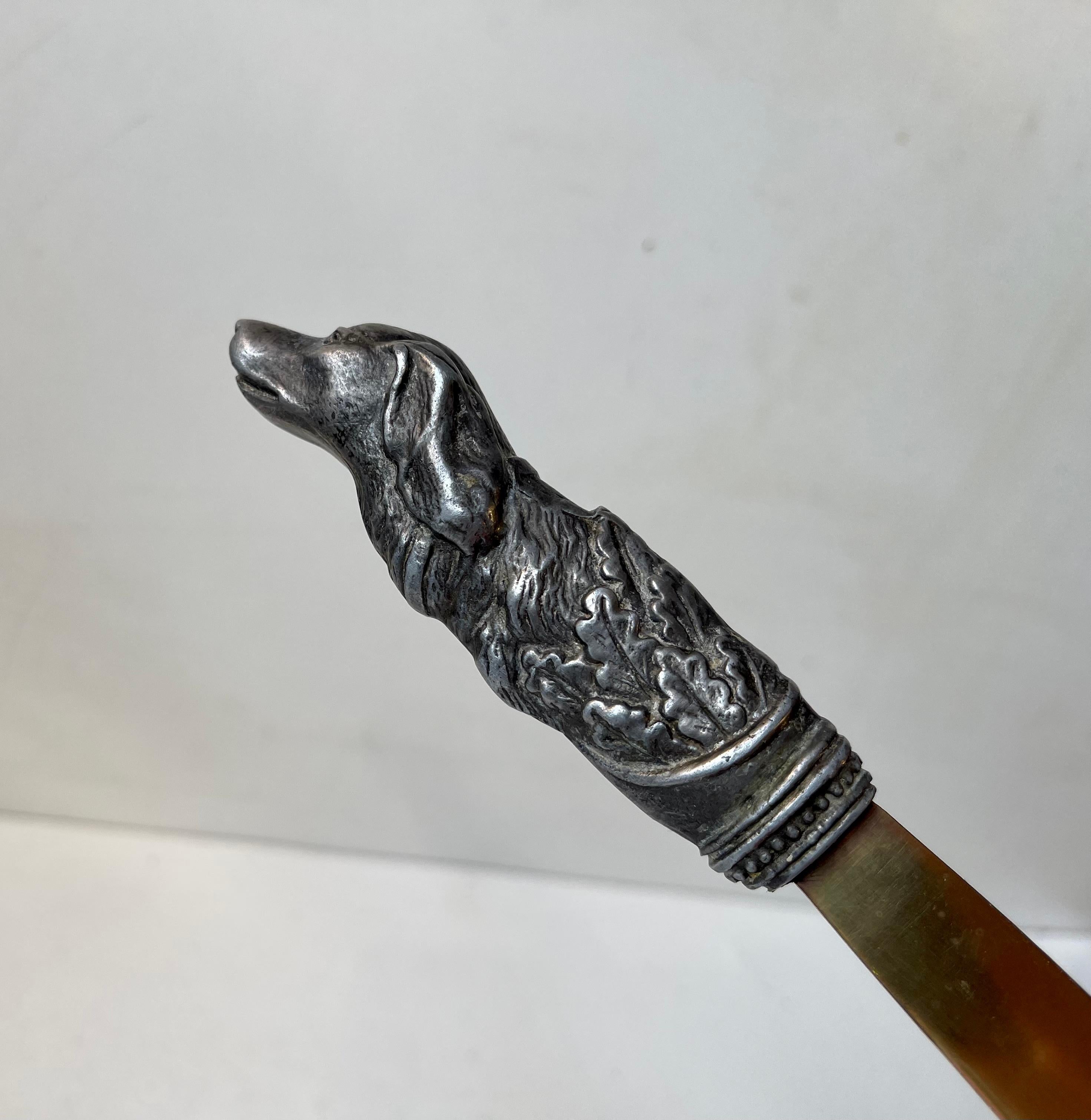 Dagger style letter opener featuring leaf-shaped blade and a handmade pewter handle depicting a hunt dog. It was made in Italy in the mid-late 19 th century by an unknown jeweler or metal craftsman. It has no signature. Measurements: H/L: 24.5 cm,
