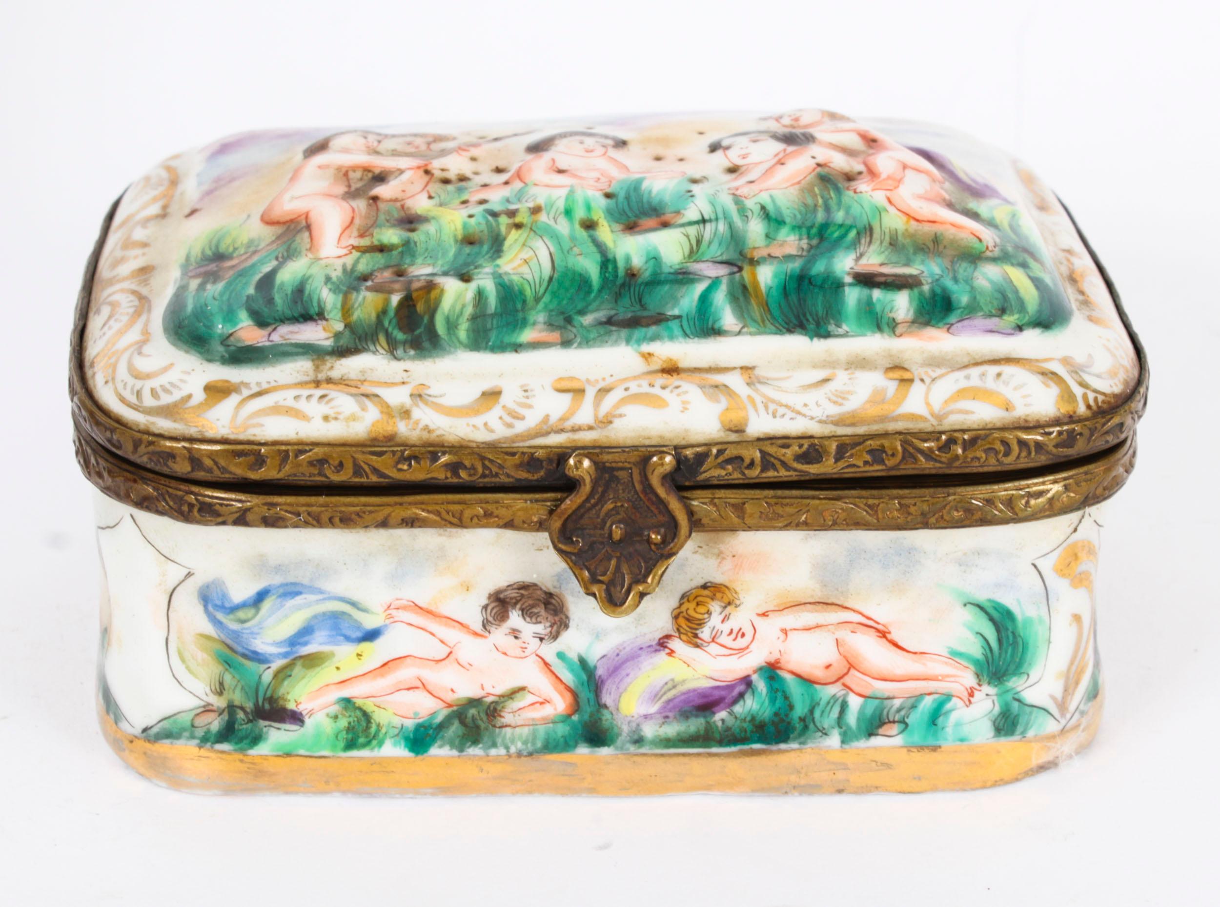 Voici une belle porcelaine italienne ancienne de Capodimonte.  cercueil, datant de la fin du 19e siècle.

La boîte et le couvercle sont superbement décorés en relief de scènes classiques, et le couvercle et la base sont ornés de montures décoratives