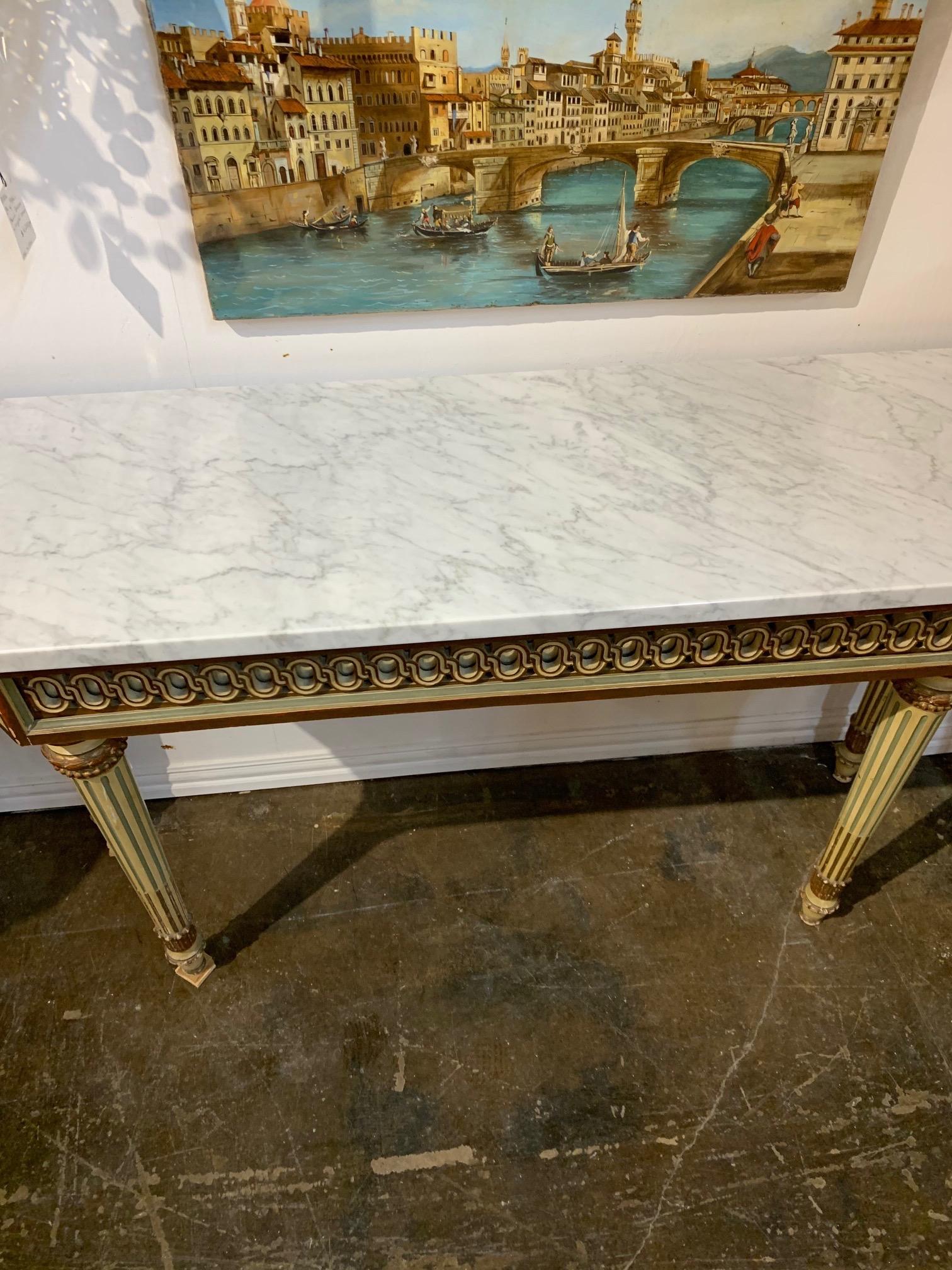 Beautiful antique Italian carved and painted console with marble top. Fabulous intricate carvings on the base and the marble is exquisite. Makes an impressive statement!