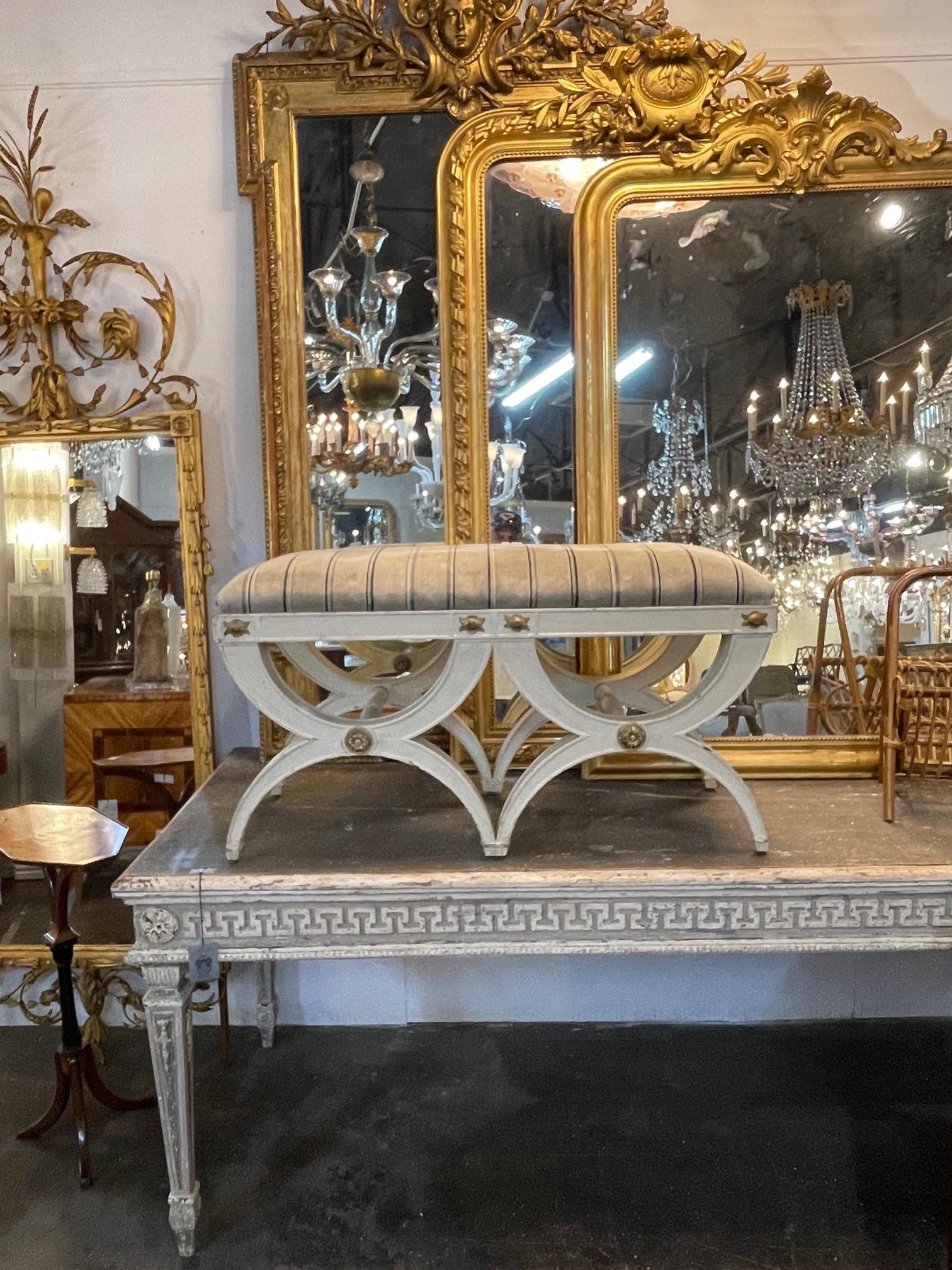 Very nice antique Italian carved and painted X form bench. Upholstered in a tan striped fabric. Functional as well as beautiful. A great piece!