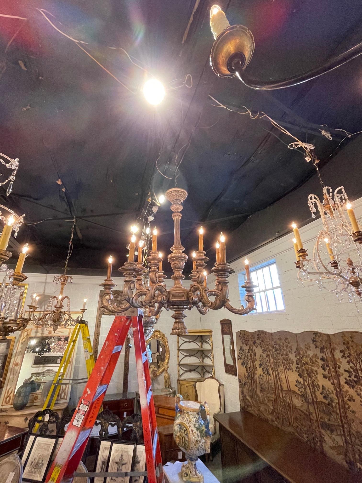 Very fine antique Italian carved and silver giltwood 12-light chandelier. The carving is exceptional on this piece.
Makes a beautiful statement!