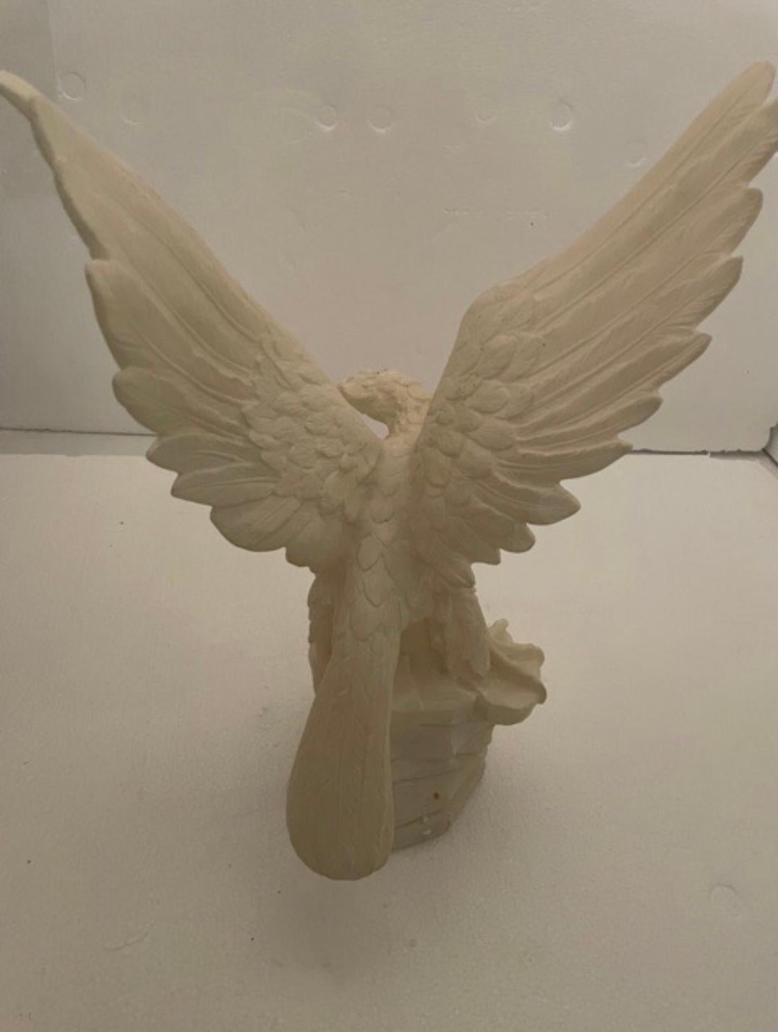 An antique Italian figural sculpture offers carved alabaster depicting eagle taking flight.
