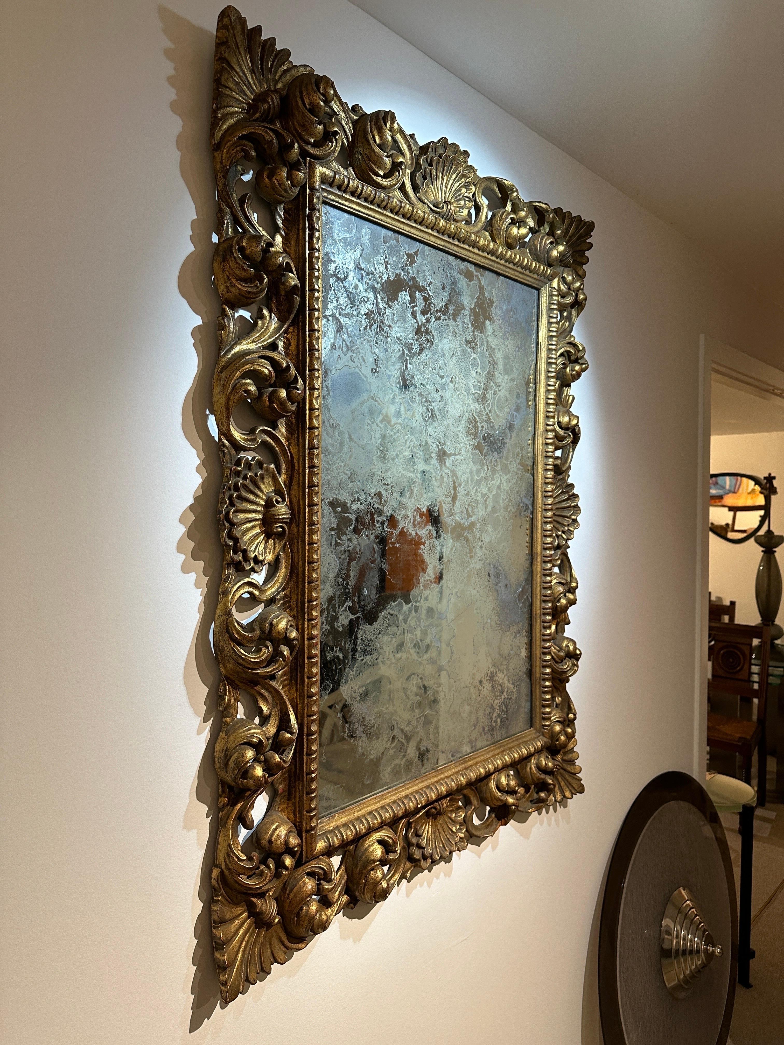20th Century Antique Italian Carved Giltwood Frame and Antiqued Glass Wall Mirror For Sale