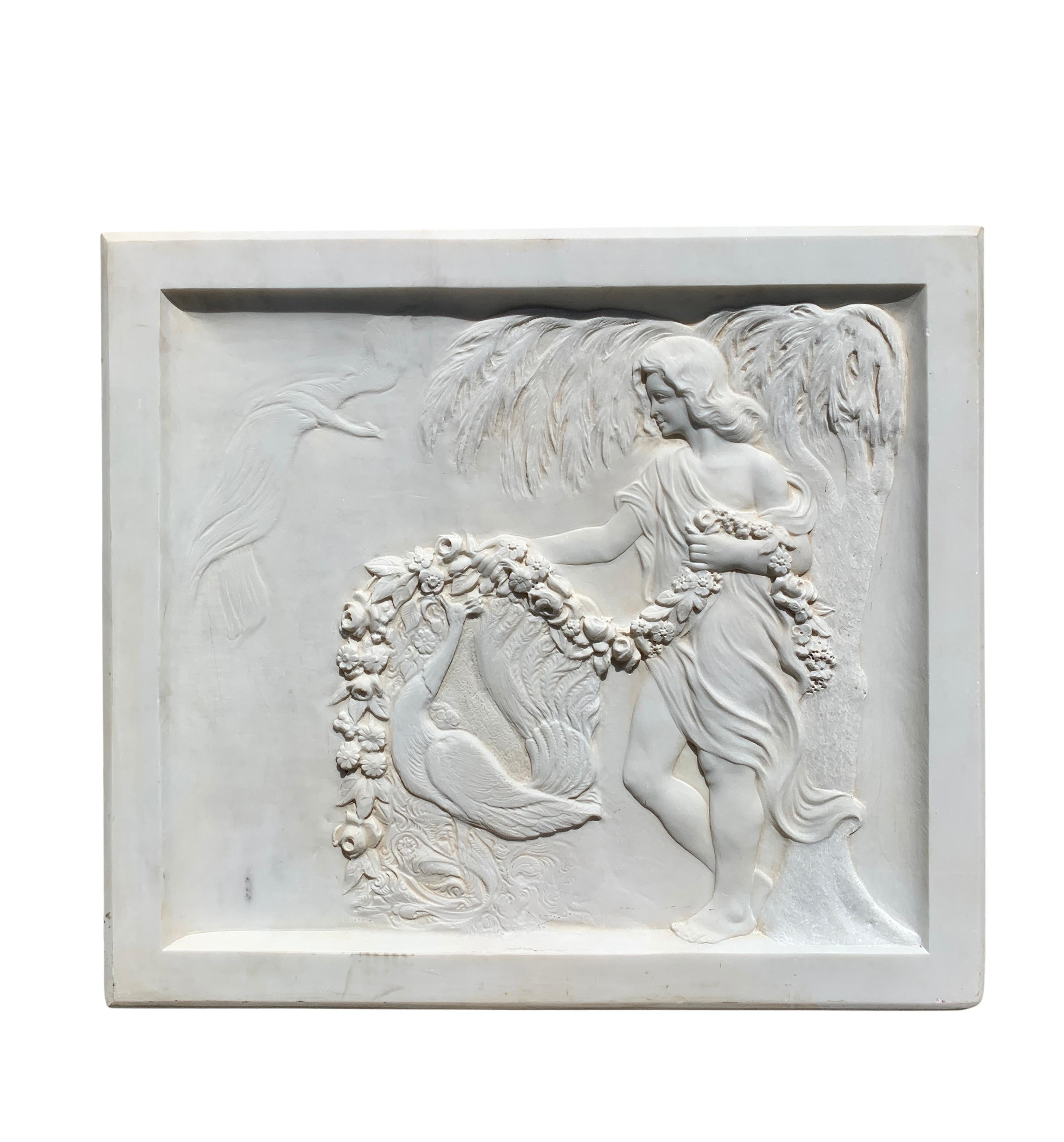 19th century Italian carved white marble bas relief depicting a lady standing by a tree holding a garland of flowers over a peacock.

Dimensions:
Height: 30.5