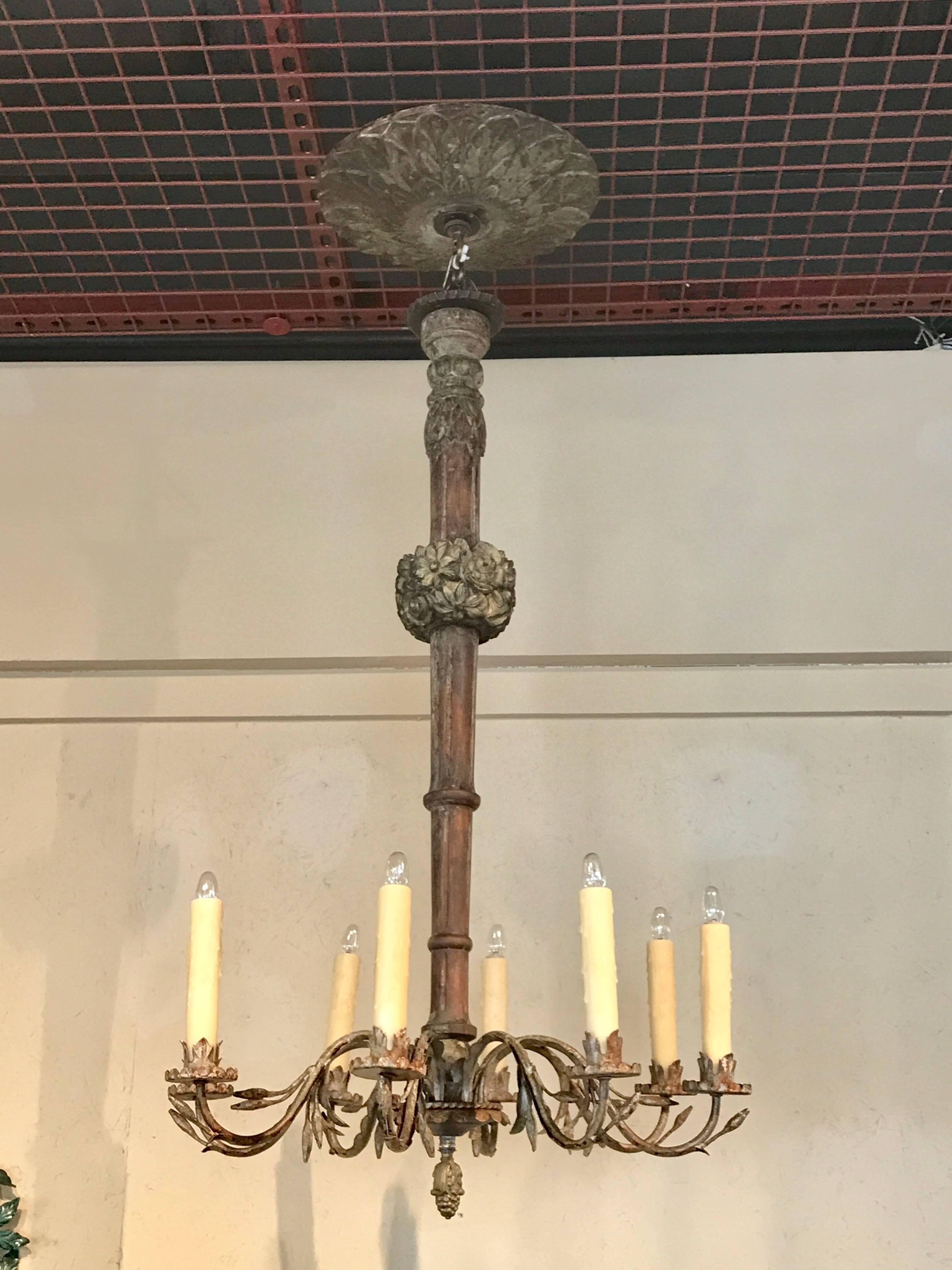 Antique Italian carved polychromed wood and iron eight-light chandelier, complete with carved canopy, now electrified. Takes standard chandelier bulbs up to 60w, shown with showroom 5watt bulbs.