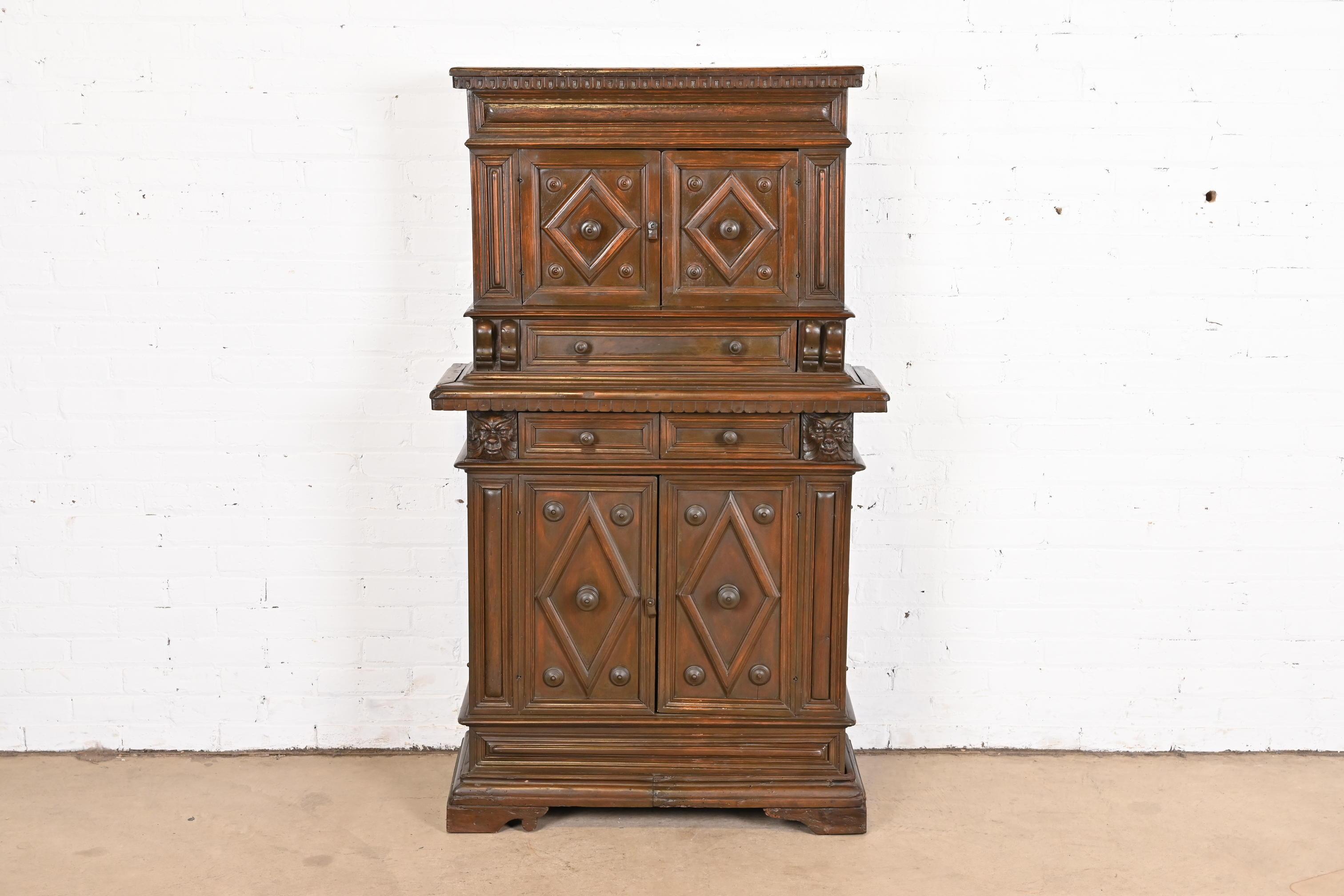 A gorgeous early 19th century Italian Renaissance Revival walnut cupboard or bar cabinet with carved faces of mythological creatures

Italy, circa 1800

Measures: 35