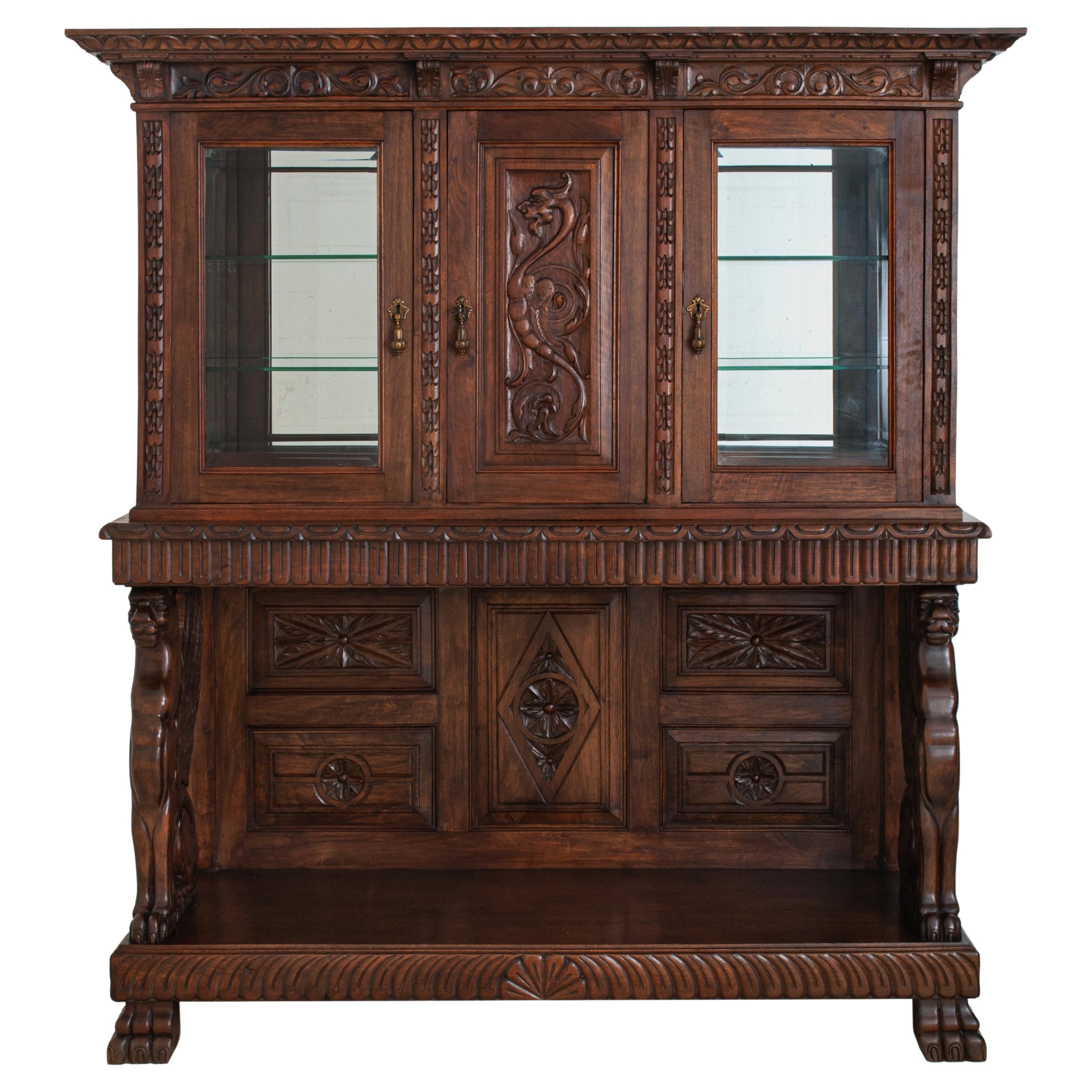 A very good, carved, Italian, Renaissance Revival 'Griffin' display cabinet, buffet, circa 1890.
The cabinet in two sections & having a heavily carved cornice supported with carved brackets. Below are three doors, the center door with a carved