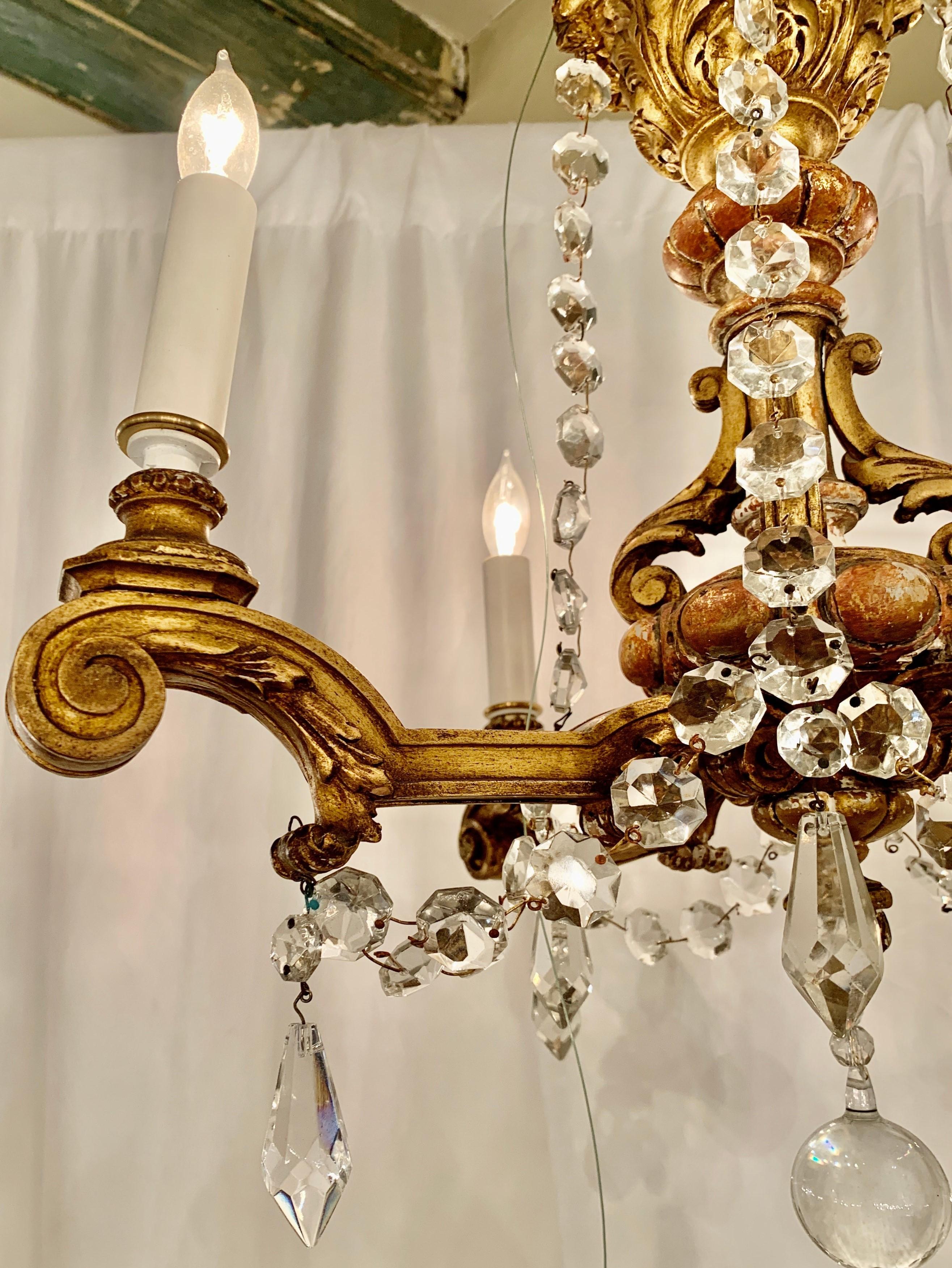 Petite antique Italian carved wood and Gesso crystal chandelier, Circa 1920s.