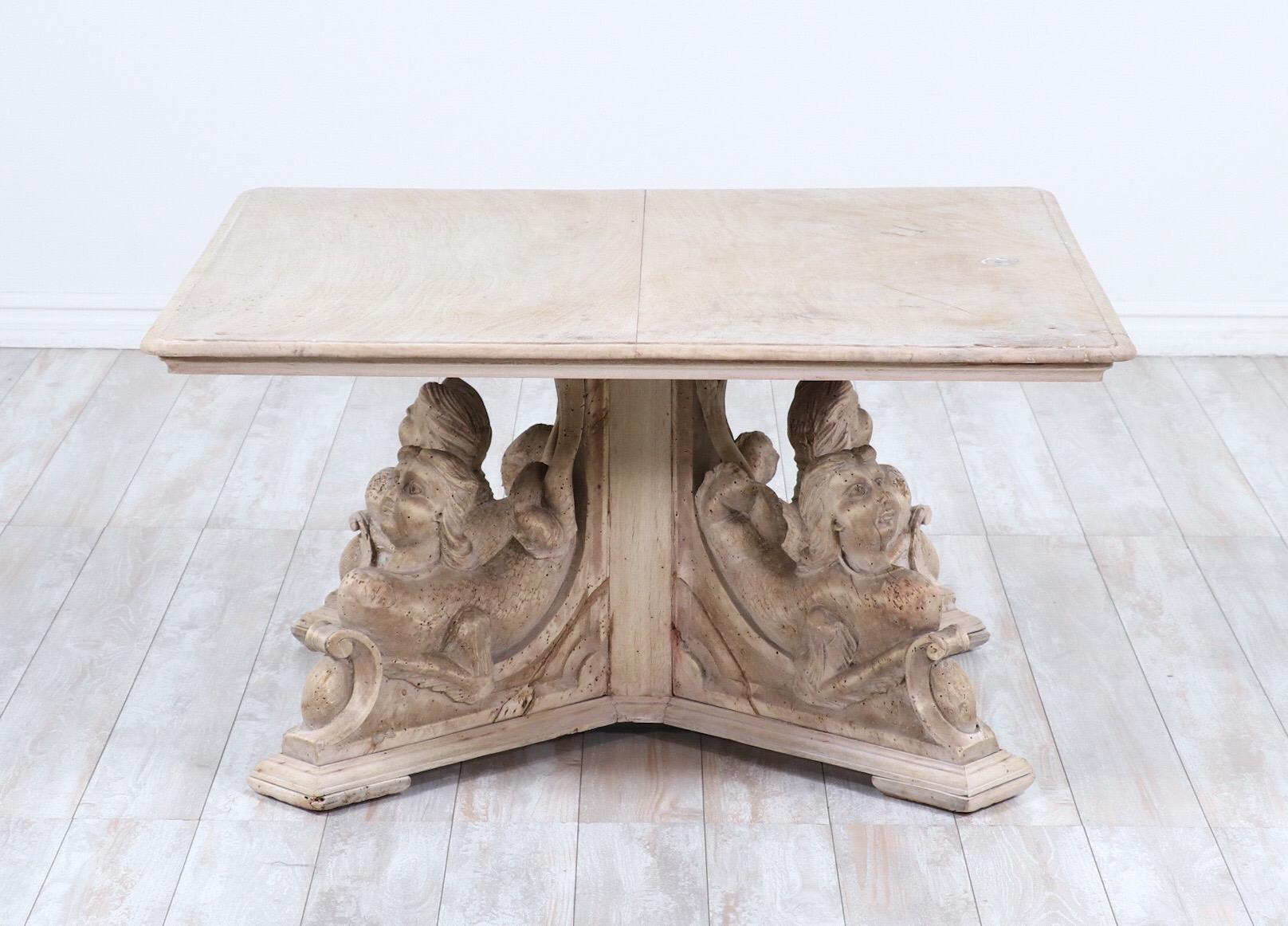 Fabulous, Italian 19th century carved wood coffee table in the Baroque style.

The table consists of a bleached and waxed carved walnut base depicting four mermaids and a square top. 

Natural imperfections and wear consistent with age including