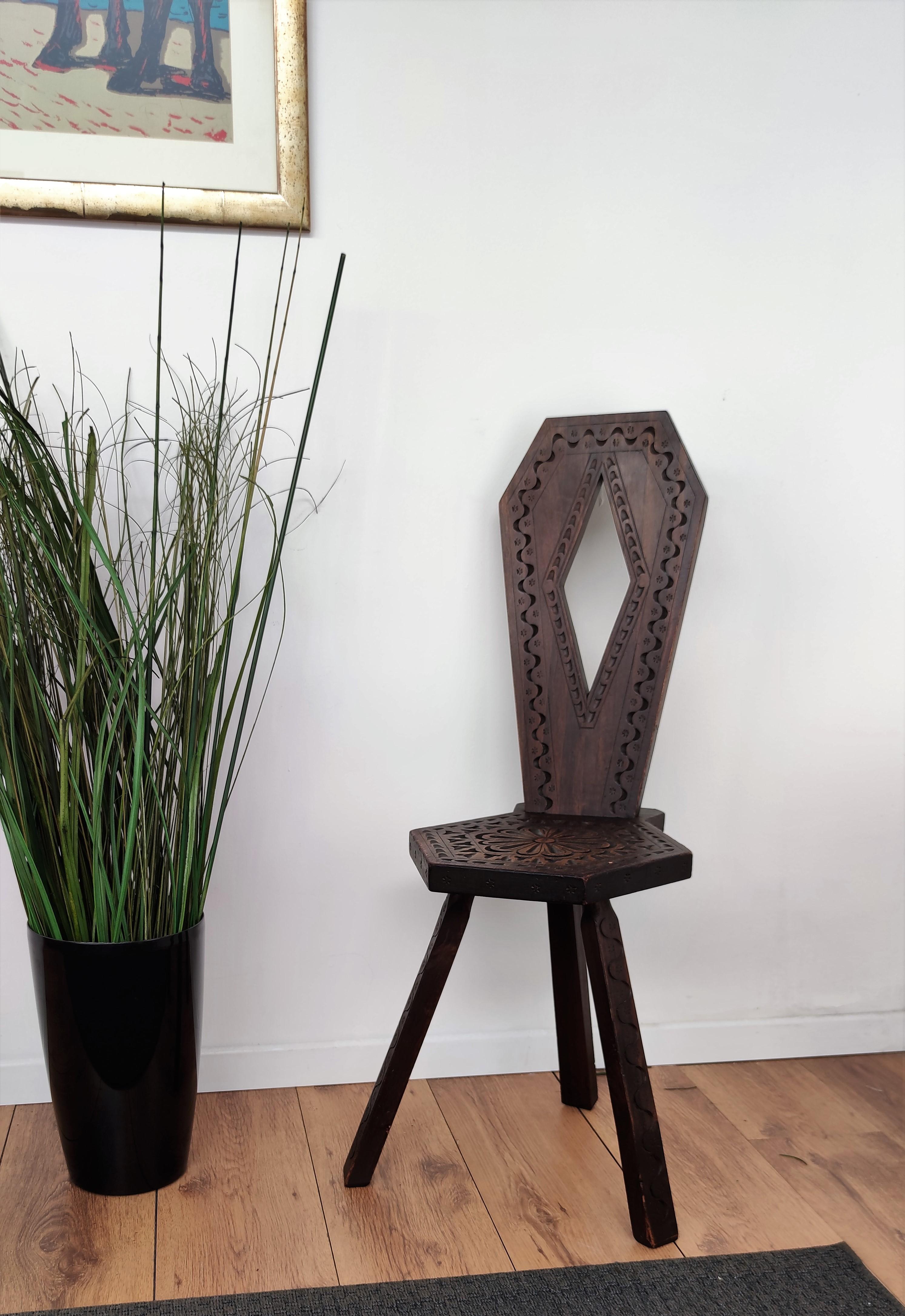Beautiful Italian tripod chair in carved wood with round top seat, great back and detailed carving on each of the three legs. The back part is fixed in antique traditional method simply by two hand-inserted sticks. Great piece in any style decor and