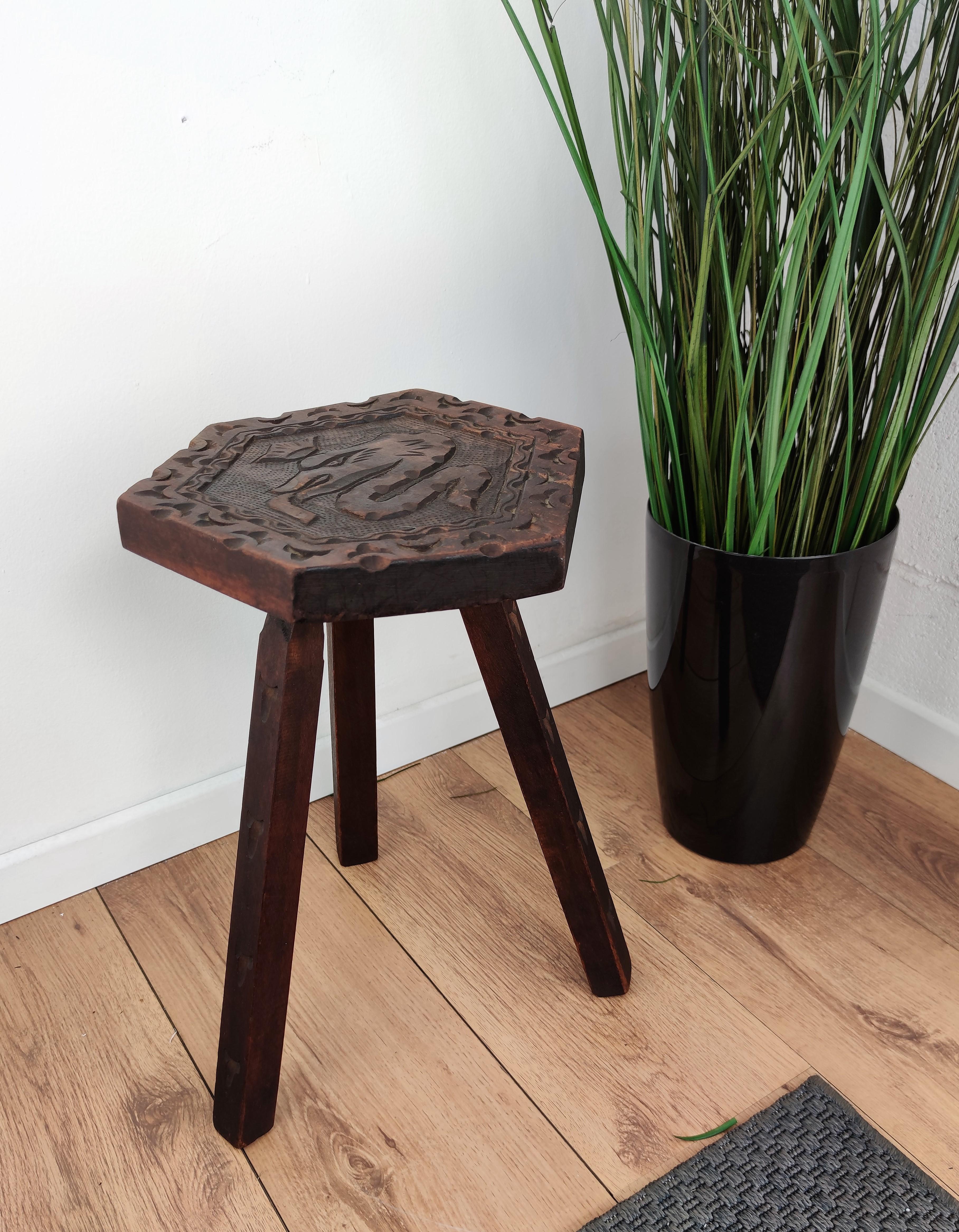 Beautiful Italian tripod stool or chair in carved wood with the so-called 'biscione' or grass snake with the crown, a historic symbol of the city of Milan, carved on the hexagonal top seat and detailed carving on each of the three legs.