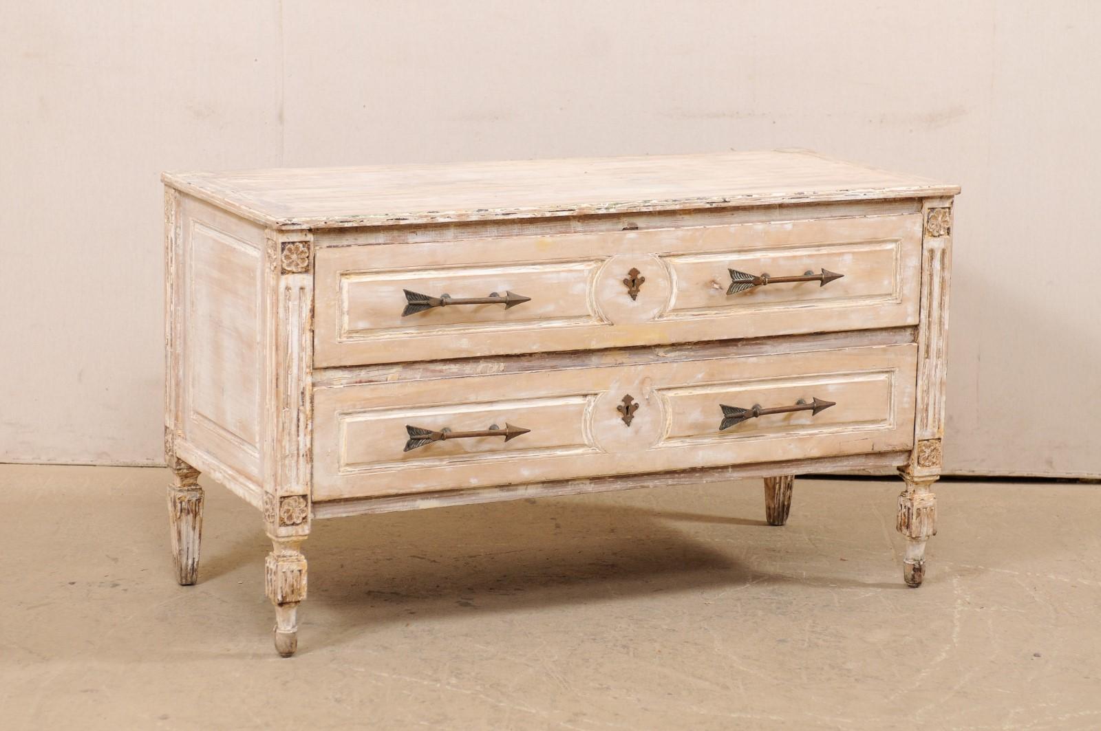 An Italian carved and painted wood raised chest of two drawers from the early 20th century. This antique cassettiera (chest of drawers) from Italy features a rectangular-shaped top, over a nicely decorated case which houses two full-sized