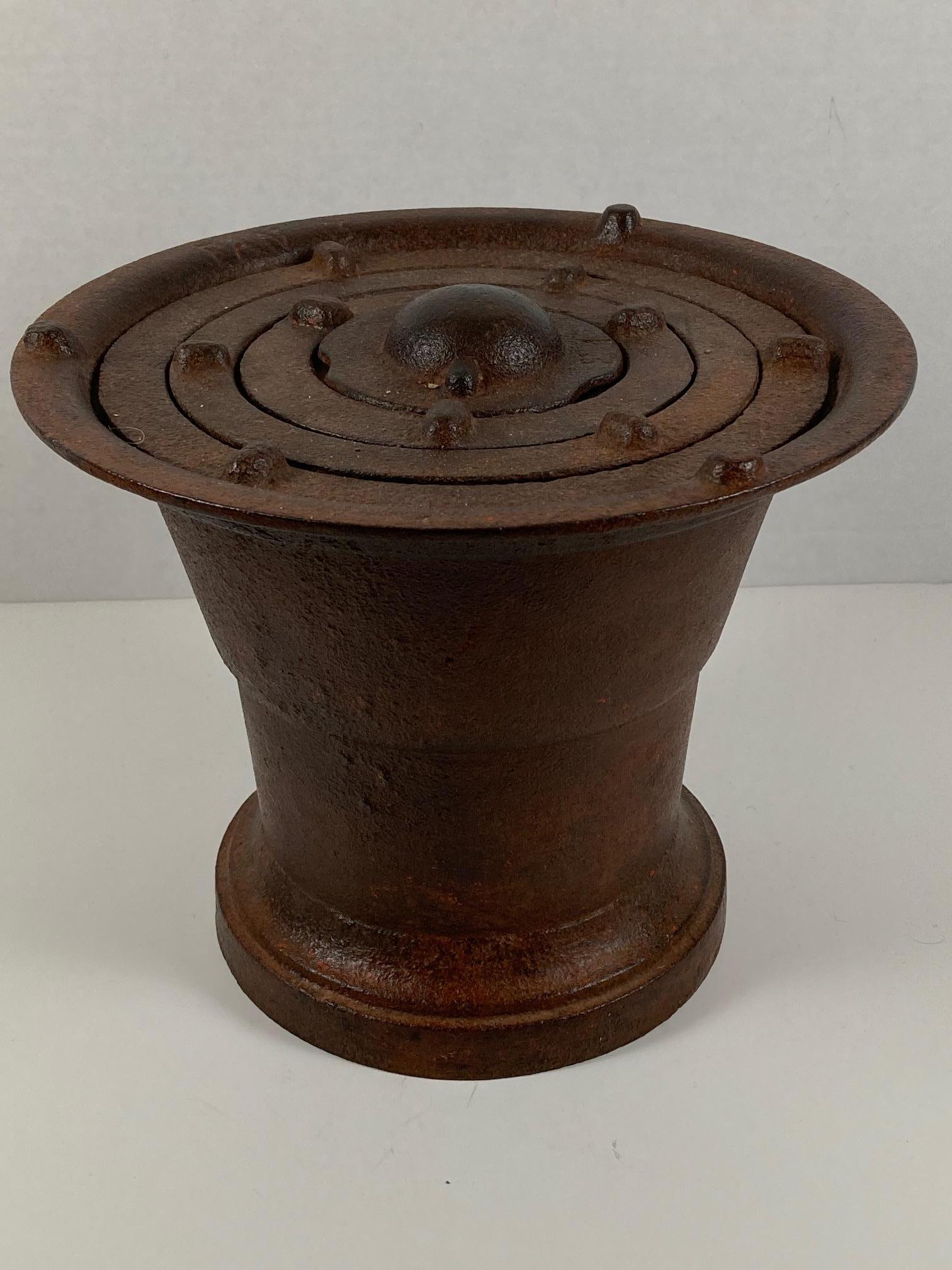 Antique cast iron cooking grill found in southern Italy. Consisting of a solid cast base with an opening for the removal of ashes, an interior slotted platform for hot coals and a series of individually removable concentric support rings on top.