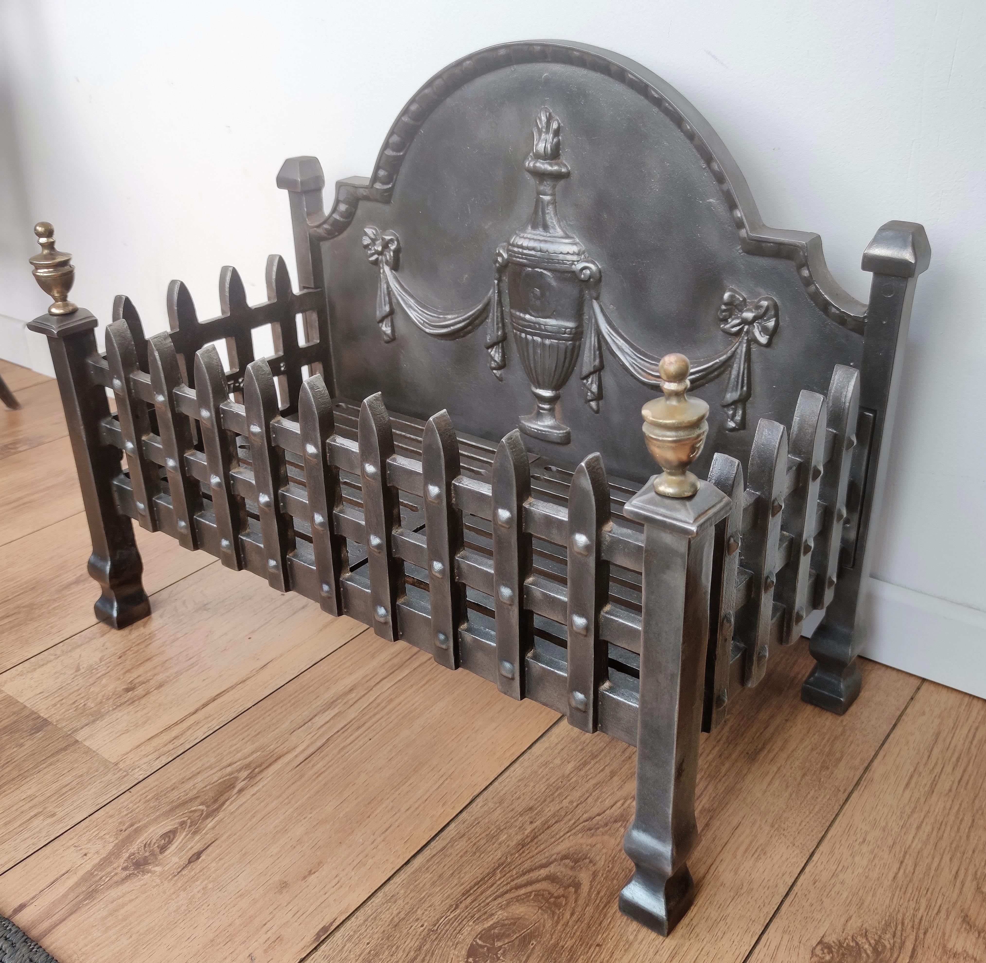 Cast iron Italian fire grate or log holder, with two beautiful neoclassical brass shapes on the sides and the decorated arched back. The item has been completey polished from previous use.