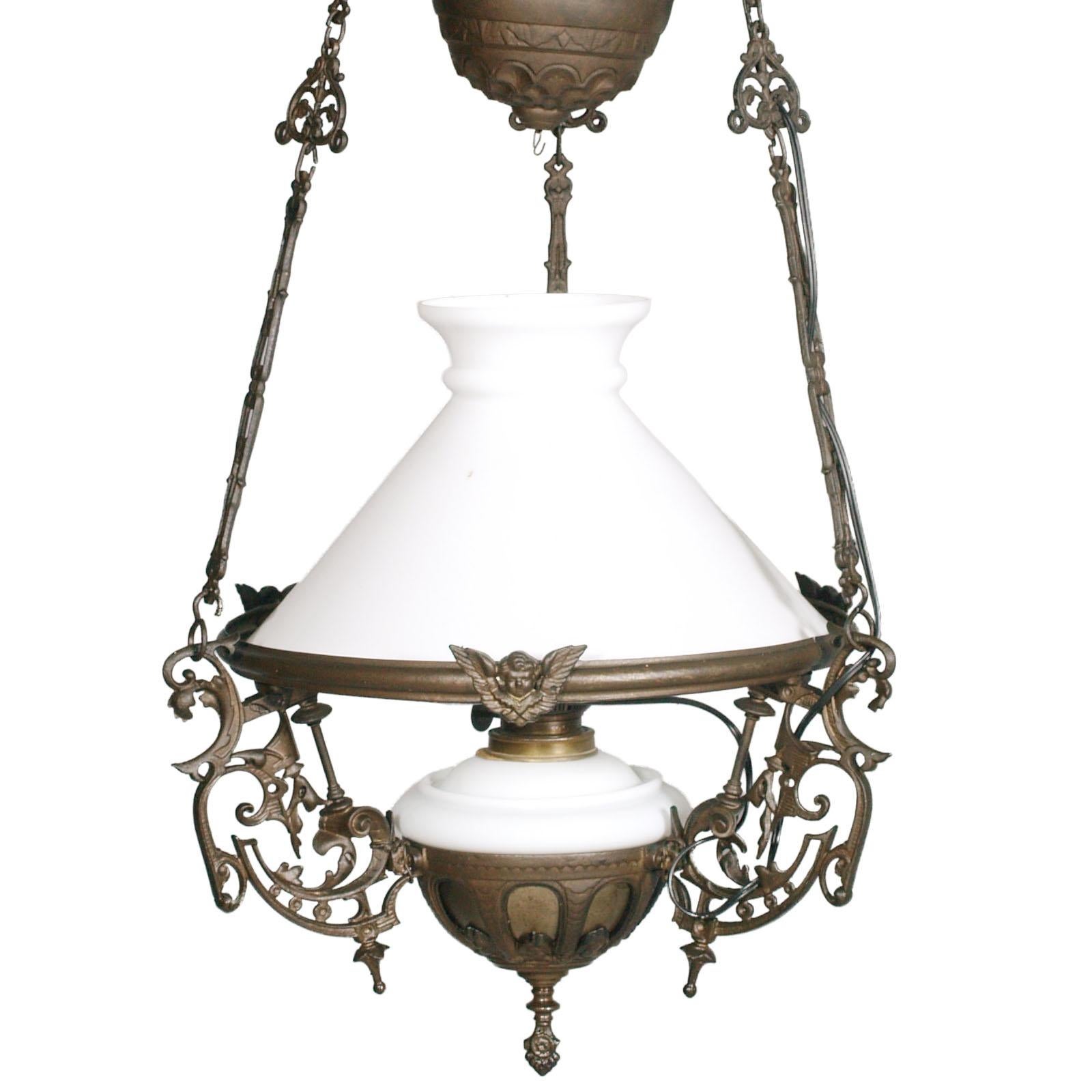 Antique Italian Art Nouveau chandelier, electrified and made from an oil lamp, in lattimo Murano glass and burnished bronze, height adjustable from cm 120 to cm 80. One light. Overhauled electrical system

Measures cm: height 90 max 135 diameter