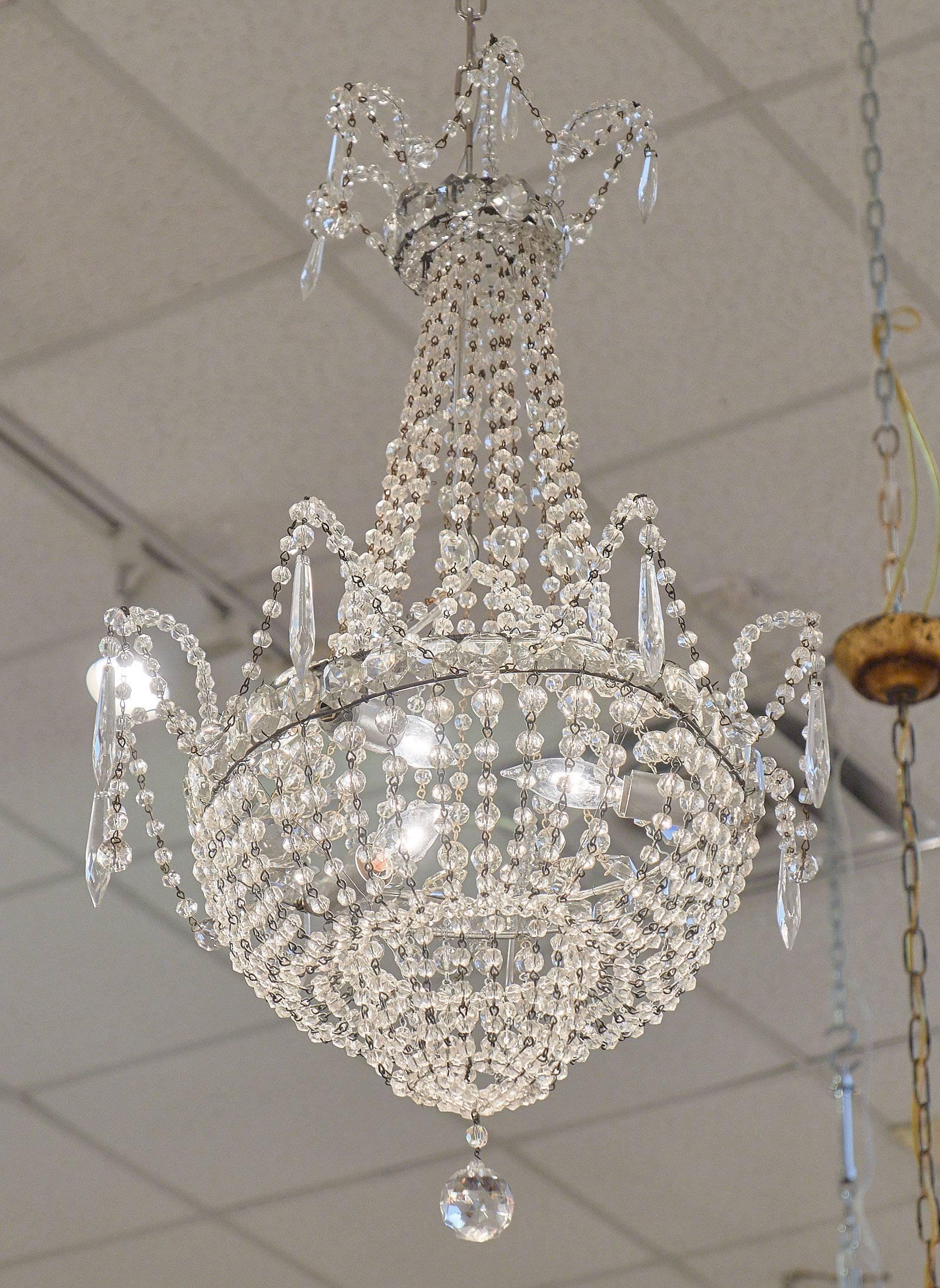 An elegant chandelier with extensive bead work and pendant crystals typical of Genovese chandeliers. This fixture has been wired to fit US standards.