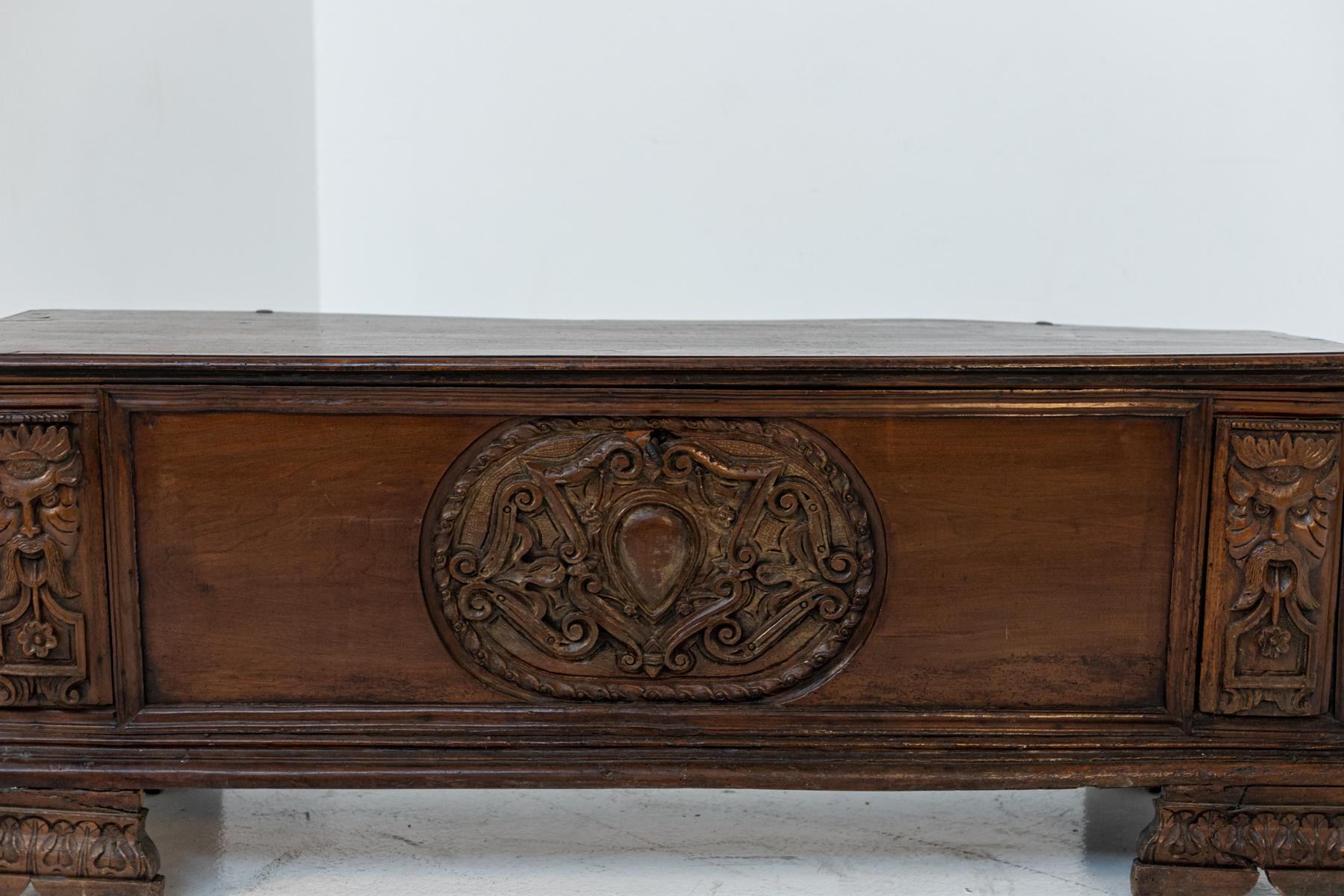 Antique bench or chest of drawers made of Italian walnut precisely from Tuscany. It is dated from the end of 500th. The wood of the chest of drawers has been beautifully worked with ornamental carvings and allegorical shapes. Note the feet also in