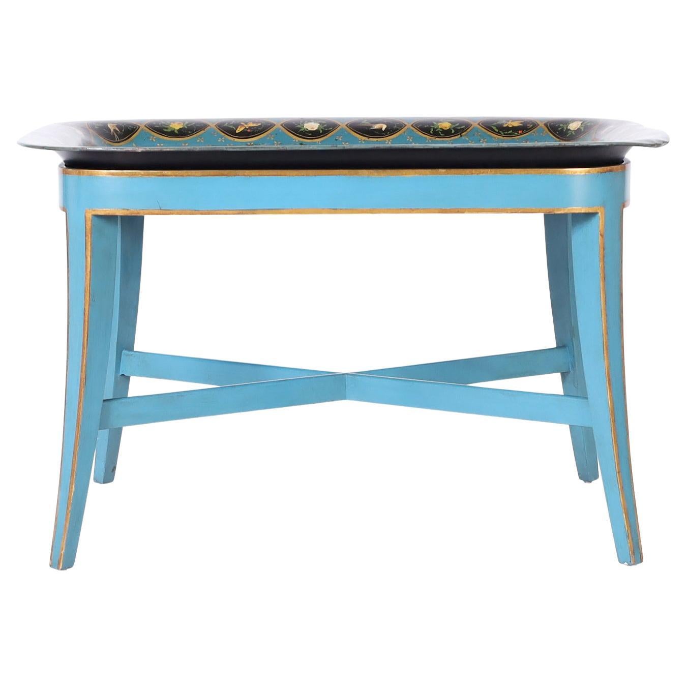 Occasional table with an antique tole tray top hand decorated with chinoiserie on a blue background with a floral border. The later custom made wood stand is painted blue with gold leaf trim.