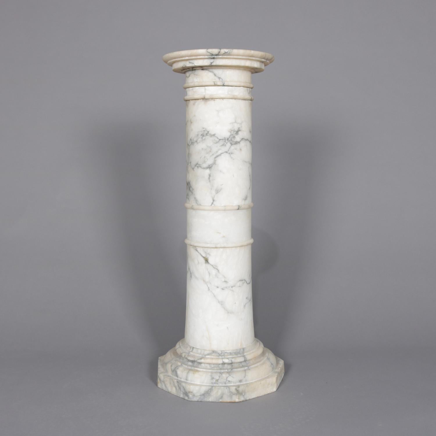 An antique Italian classical sculpture pedestal features carved marble construction in Corinthian column-form and having round display platform, marble with deep veining, circa 1890.

Measures: 35.5