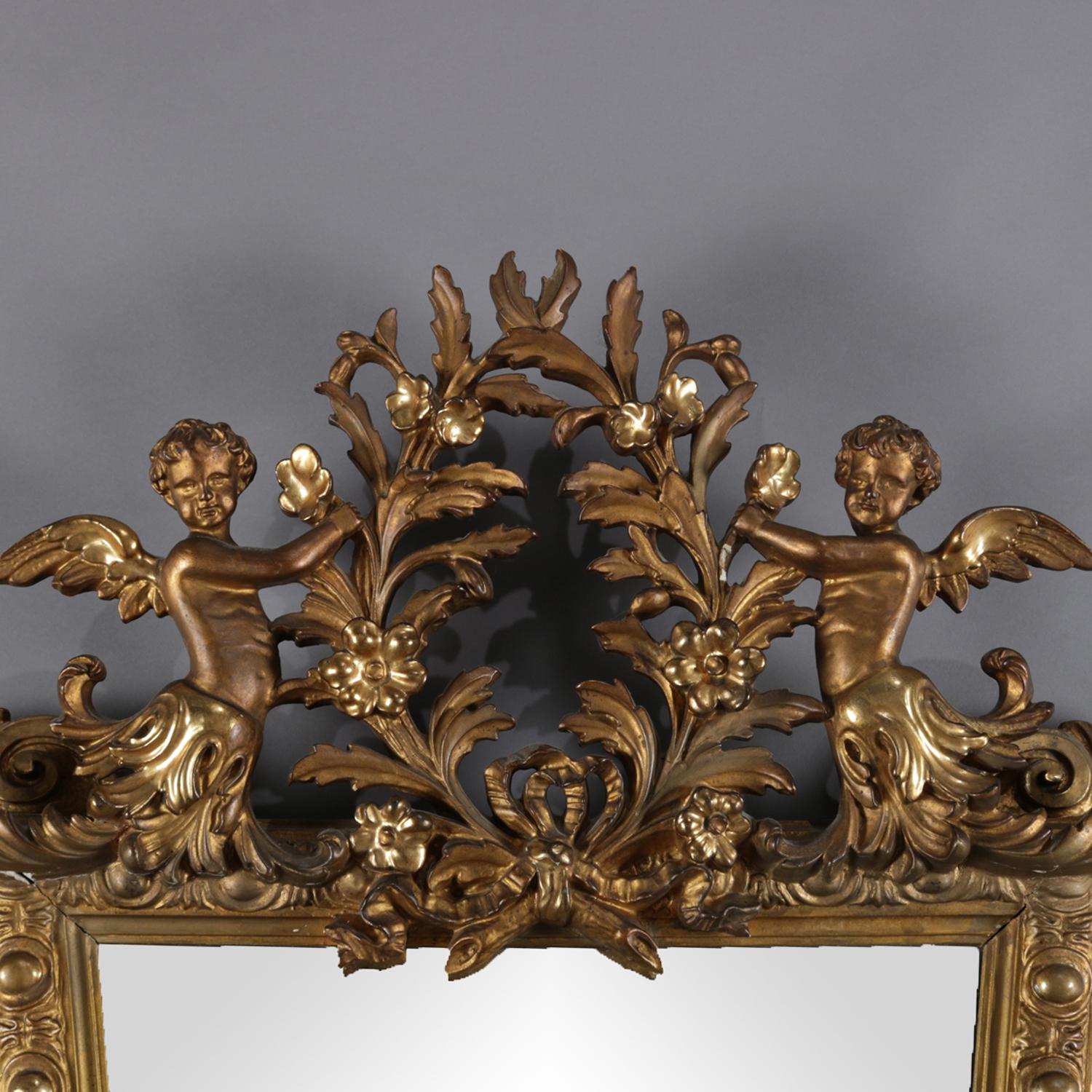 Antique Italian Classical and figural wall mirror features pierced crest with central foliate form wreath and flanking cherubs, tapered form frame with foliate decoration terminates in pierced fleur de lis apron, 19th century

Measures: 45
