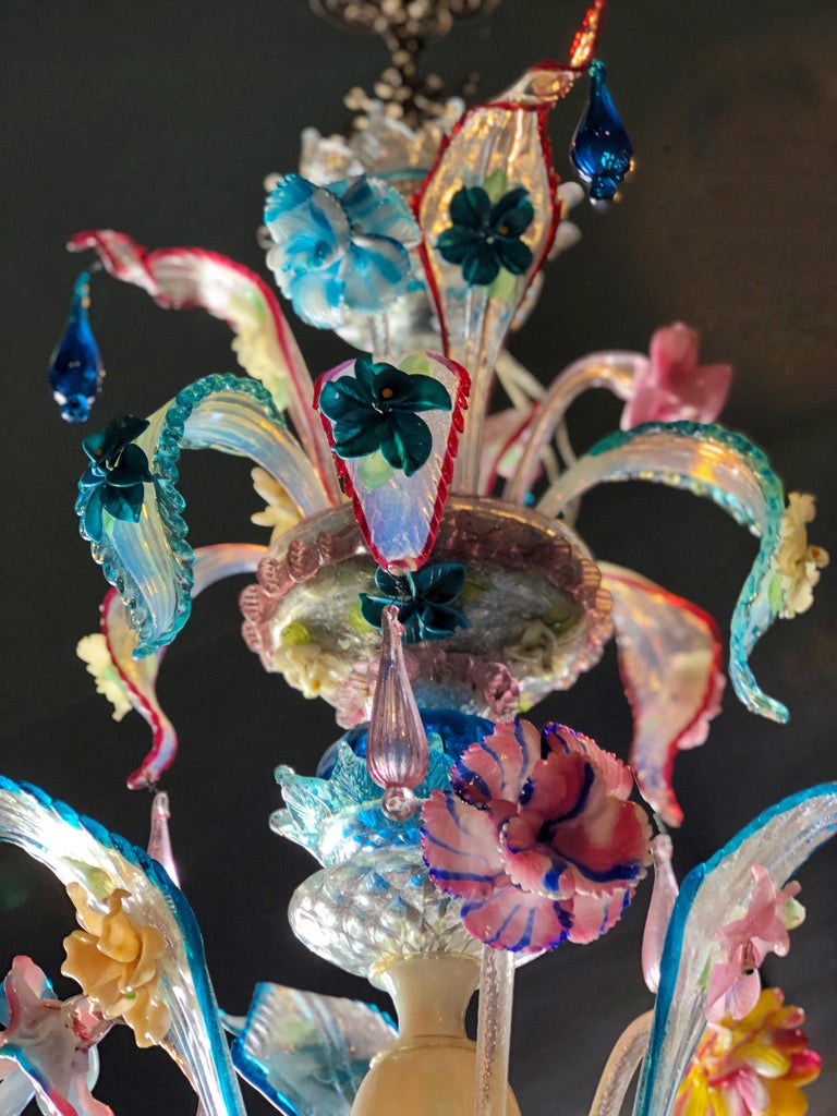 Magnificent antique colorful Ca'Rezzonico Murano glass chandelier from Italy from circa 1890.
The colorful Murano chandelier has a total of 6 lights spread over three levels made from hand blown Murano glass, as well as from very rare opaline