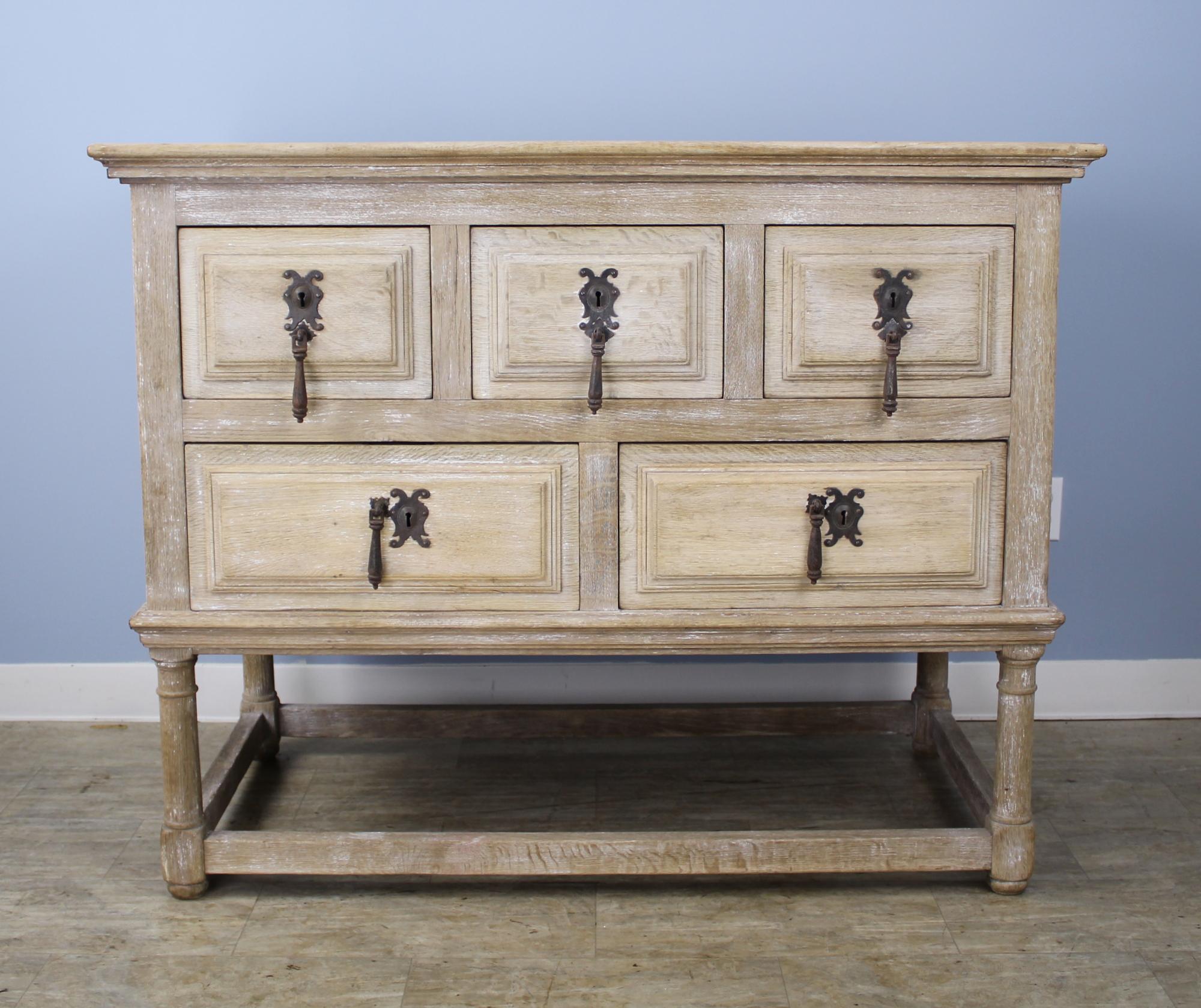A handsome deep Italian commode or kitchen chest, with original paint that has been recently scrubbed back for a faded, modern look. Five deep drawers slide easily. The piece is the right height for common room storage and additionally as a work