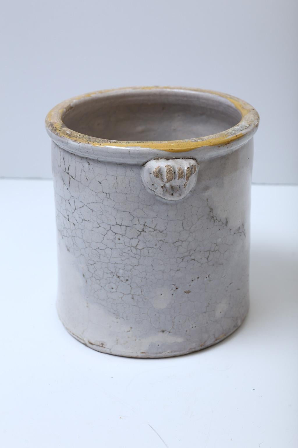 Antique Italian confit pots with ornate knobs and a touch of yellow glaze around the rim. We have two of these currently in stock. Price listed is per item. These are handmade pots and sizes vary slightly.