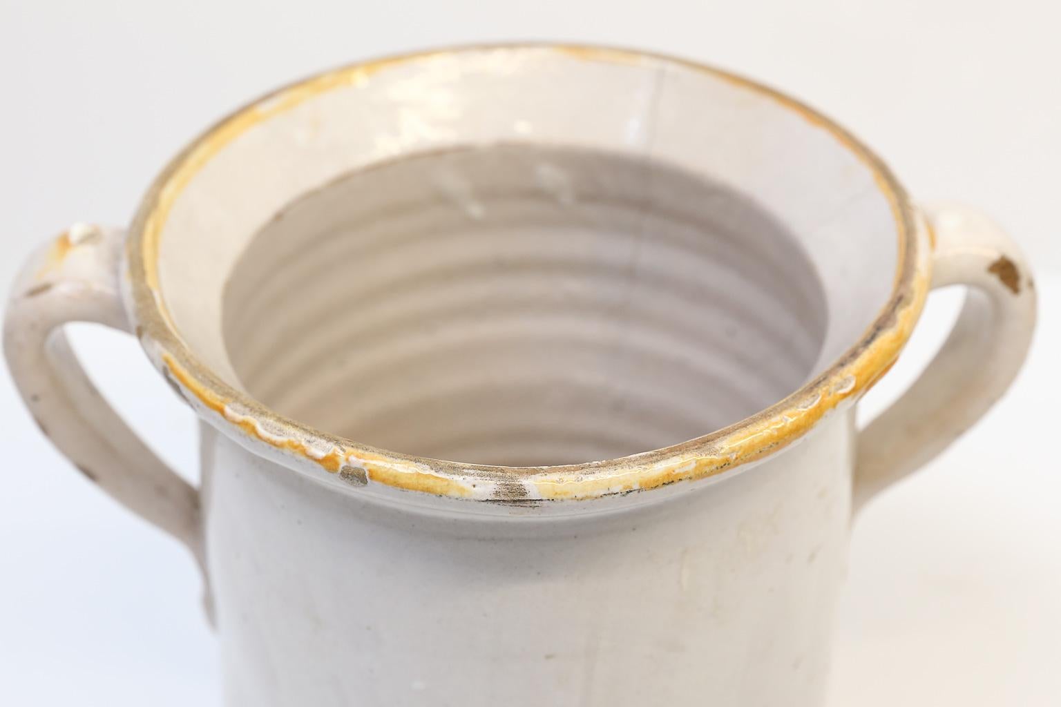 Antique Italian confit pots with handles and touch of yellow glaze on top rims. We currently have four in stock. Price listed is per item. These pots are handmade and slightly vary in size.