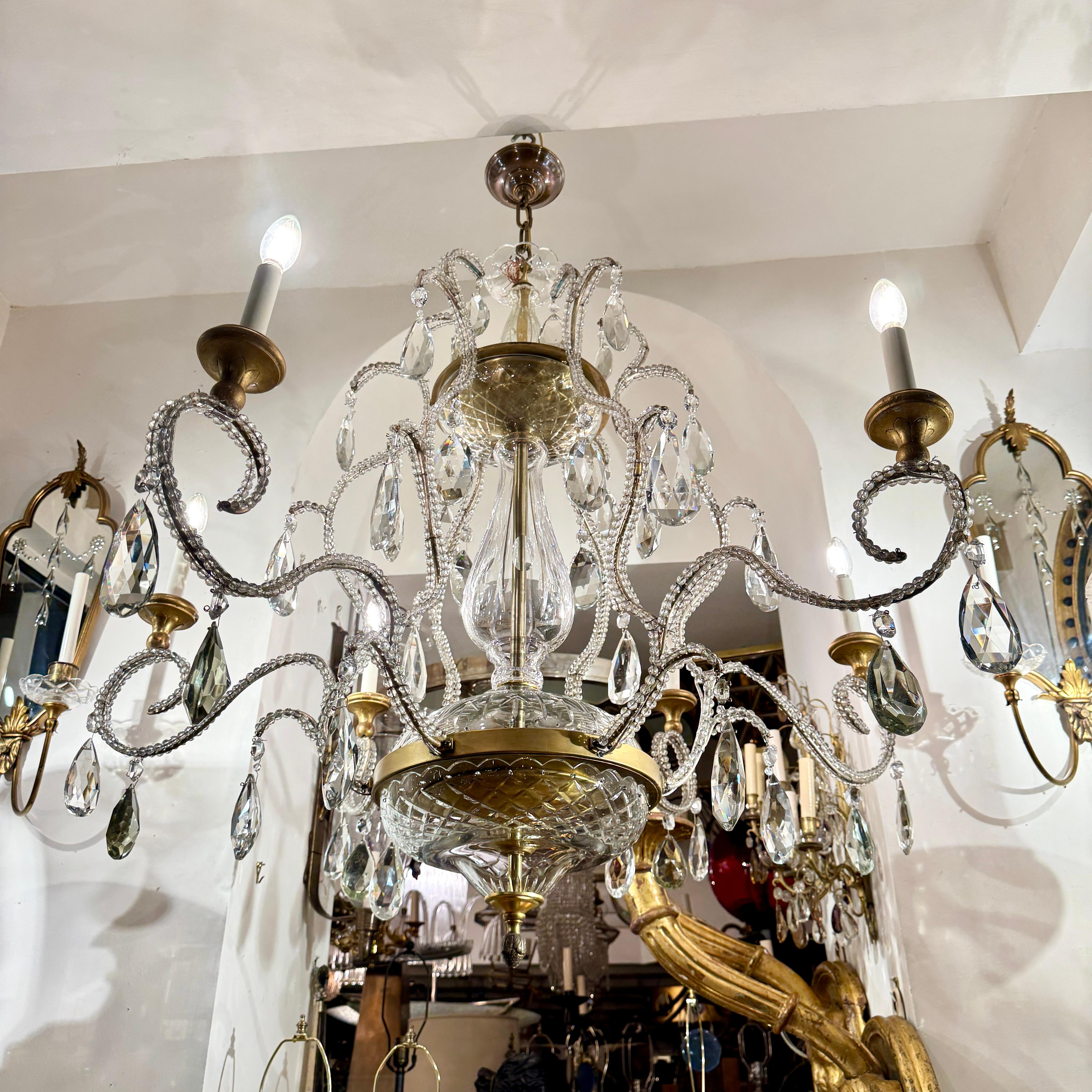 A circa 1950's French gilt wood and metal chandelier with crystal beads, 6 candelabra lights.

Measurements:
Diameter: 44