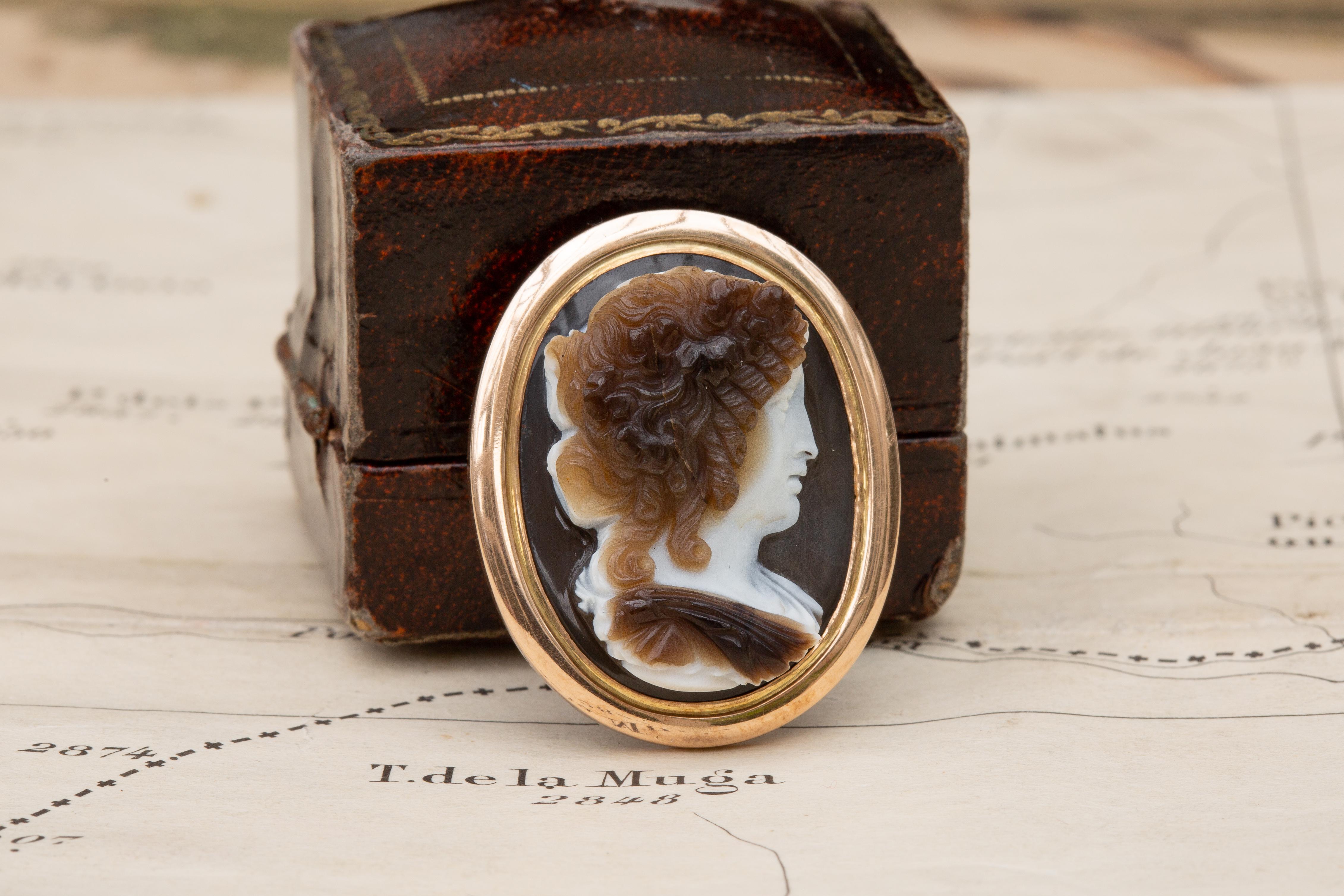 A stunning early 19th century Italian hardstone cameo pendant, probably circle of Nicola Morelli. This beautiful four layered agate is carved from one stone with great skill to reveal the bust of a Bacchante. The carver cleverly uses each of the