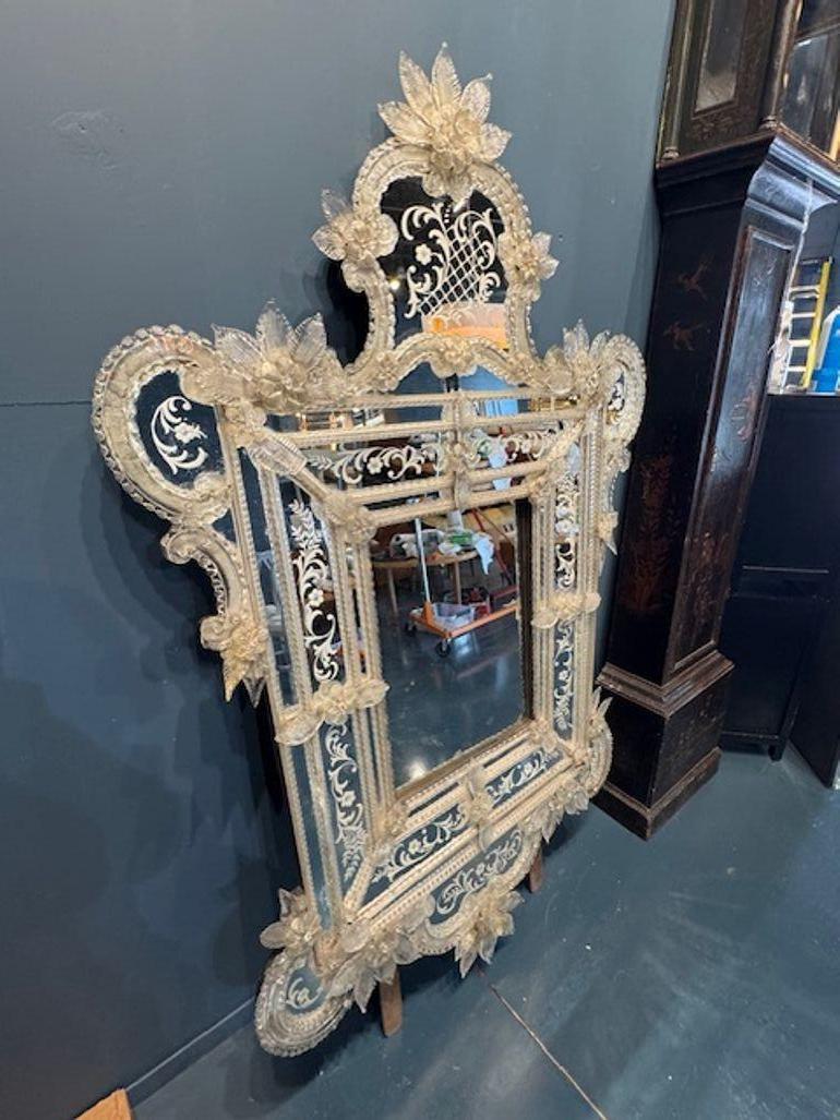 Experience the elegance of Renaissance Italy with this Antique Italian Etched Venetian Mirror. Its intricate etchings are a testament to the craftsmanship of a bygone era, making it a timeless addition to any room. The mirror's ornate design