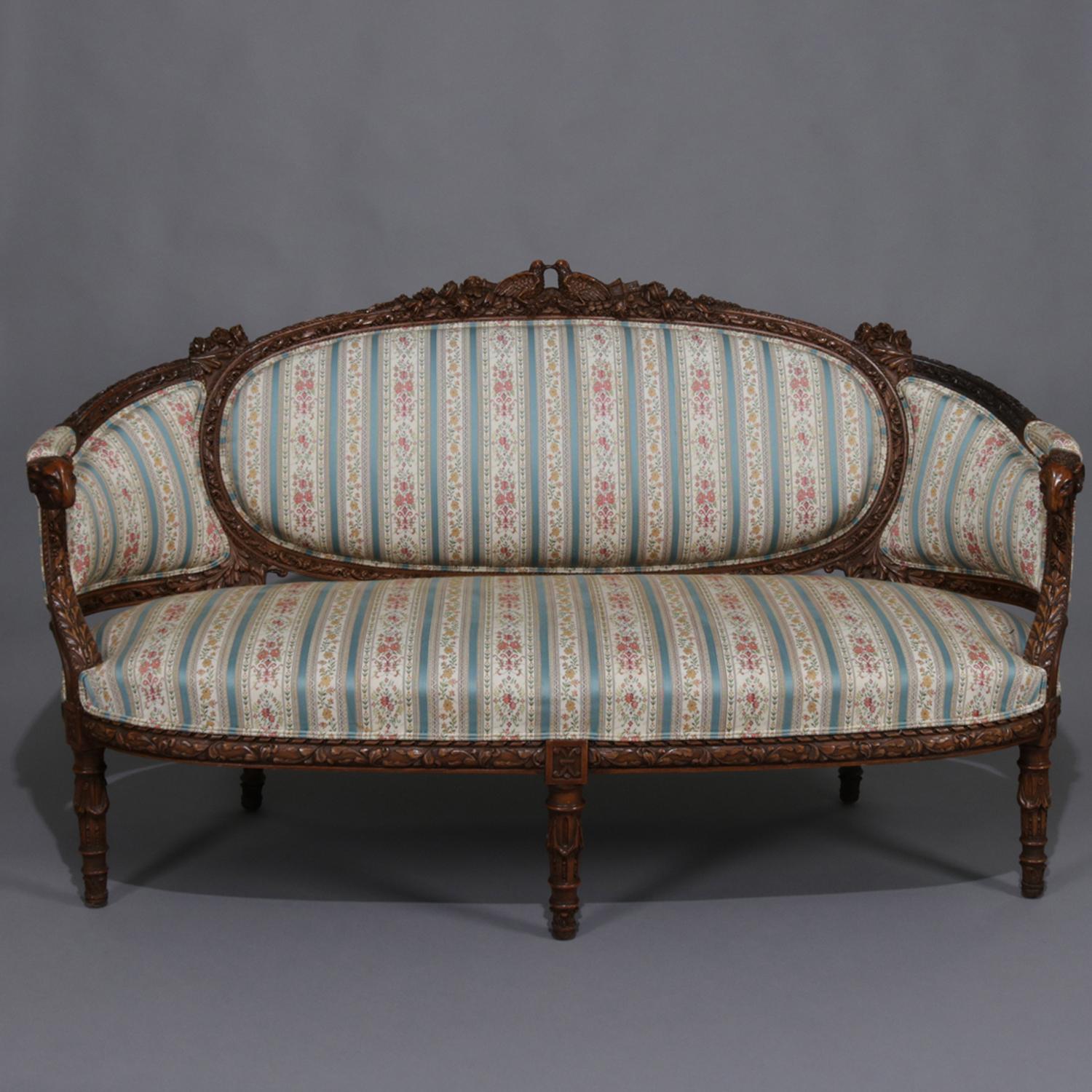 Antique Italian figural three-piece upholstered parlor set features carved walnut frames with doves, flowers and ram heads, includes settee with two arm chairs, 19th century

Measures: settee 66
