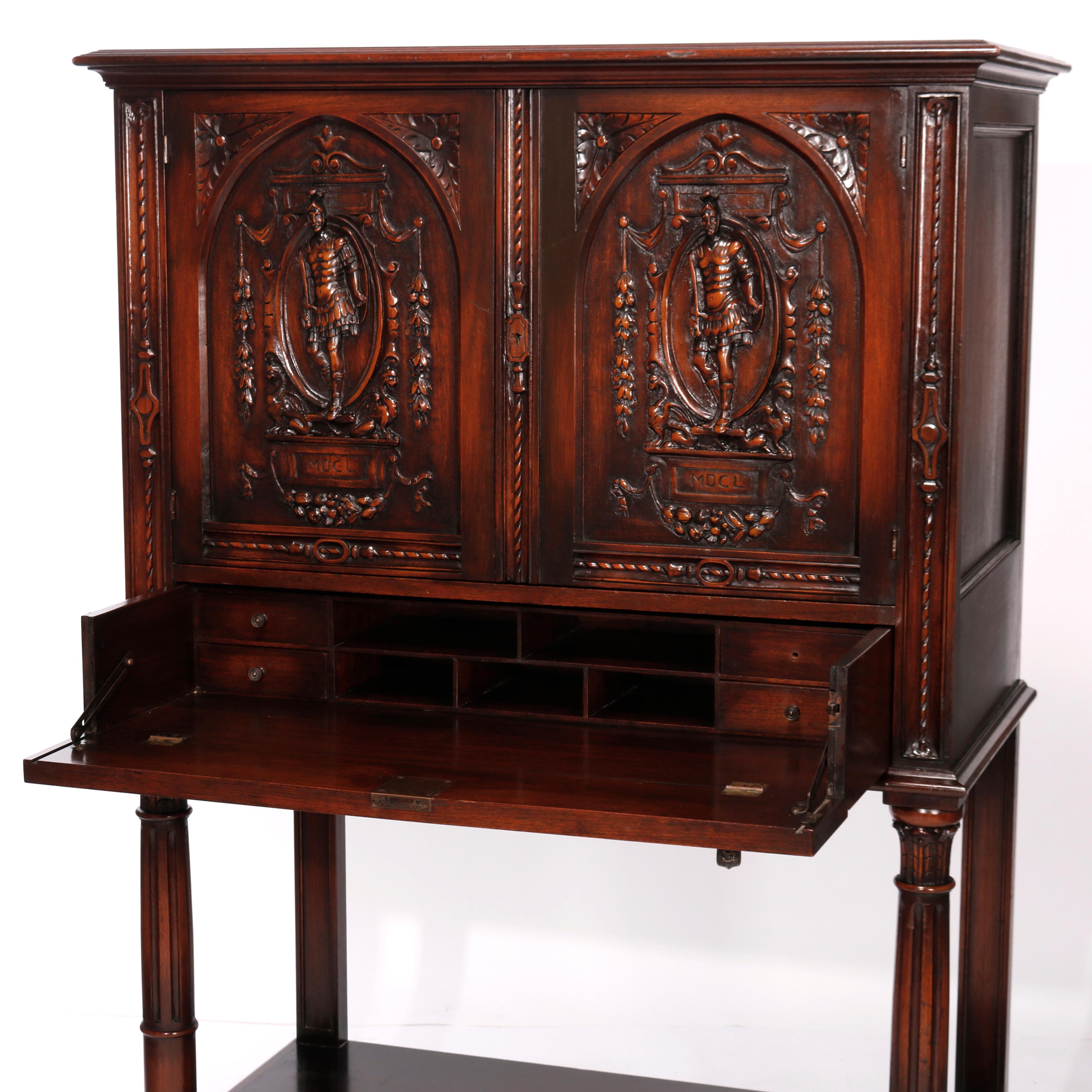 An antique Italian figural secretary credenza offers walnut construction with upper having double doors with figural carving in relief depicting soldiers or knights over lower drop down desk raised on turned legs with lower display, foliate carving