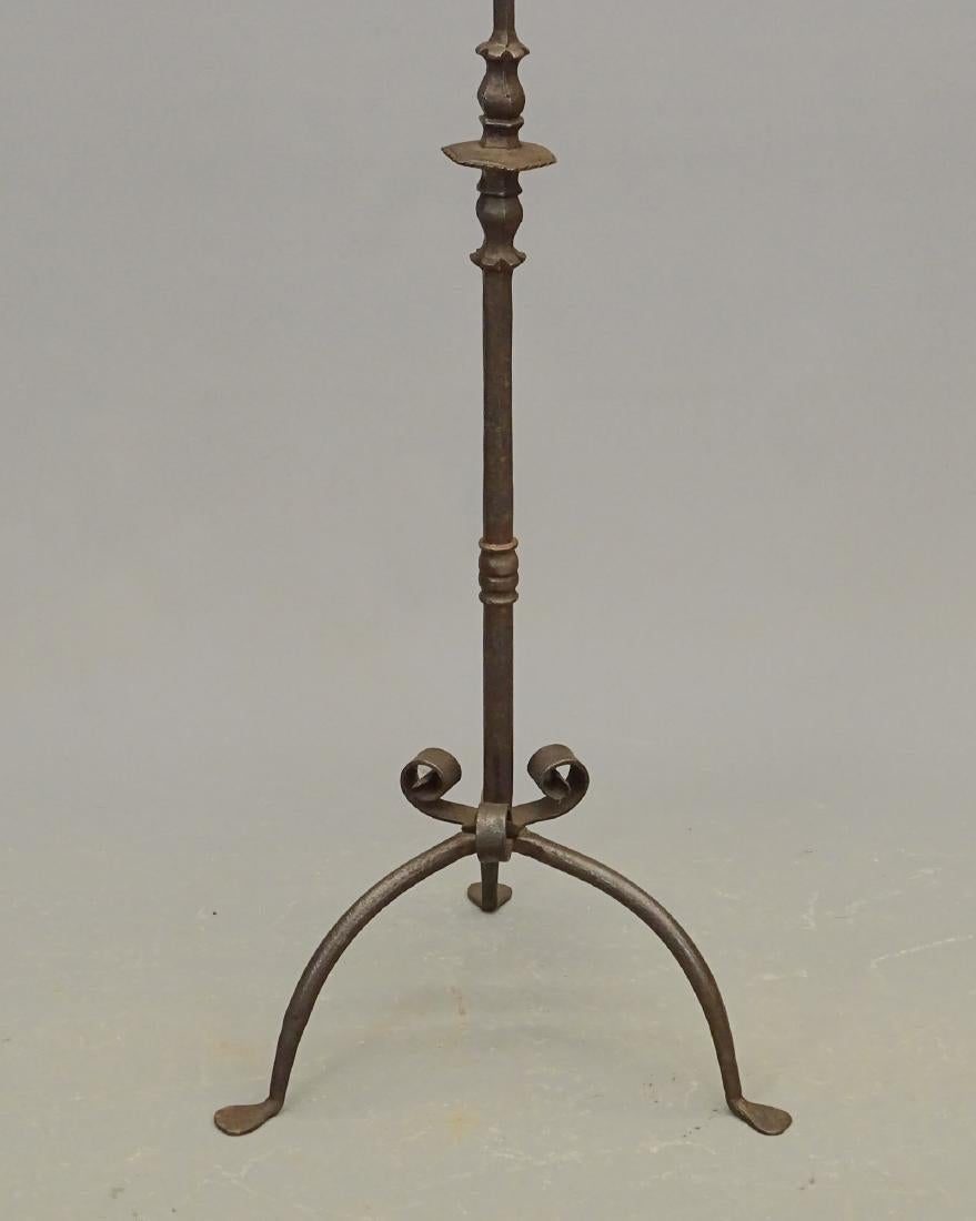 Beautiful 19th century Italian antique forged iron candelabra. This forged iron candelabra torchere has one large pricket, two candle holders, forged stem and a base with three curved legs. Stunning features and iron technique make this antique