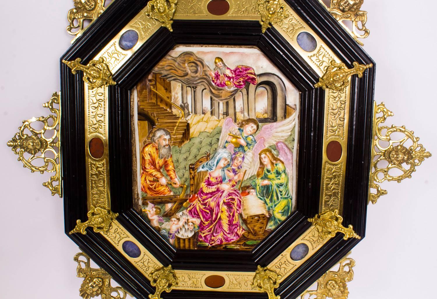 This is a beautiful large antique Italian Capodimonte porcelain plaque, circa 1820 in date. 

The plaque is housed in a decorative ebonized frame that has a plethora of ormolu mounts that are inset with semi precious stones including lapislazuli