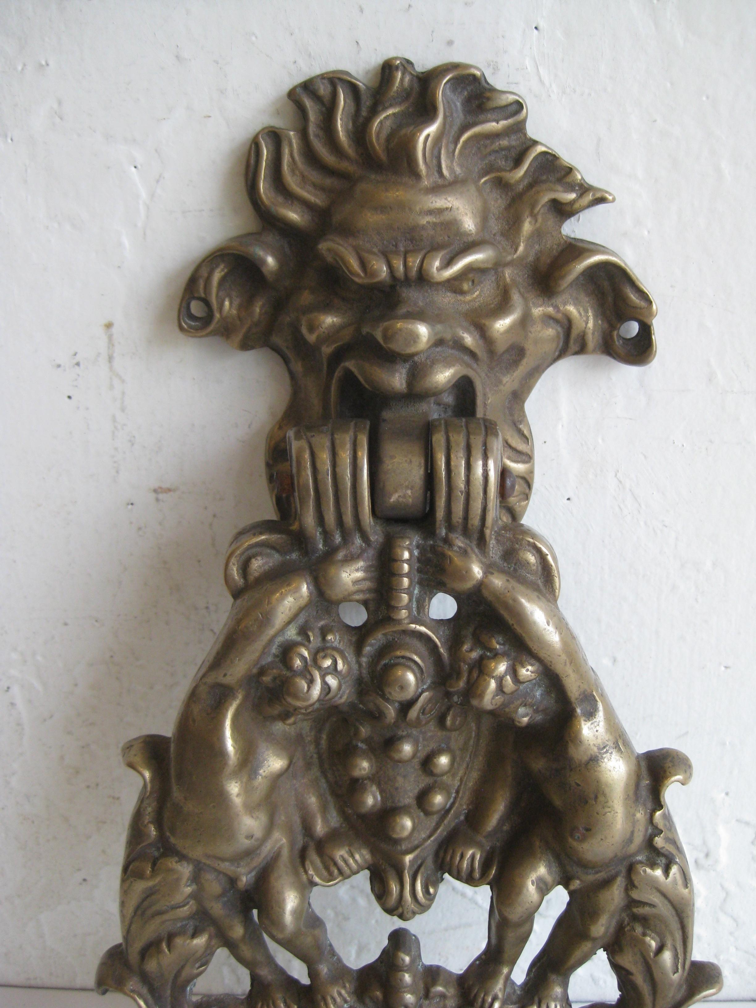 Very unique antique cast brass Italian/French Gothic cast brass door knocker. Great design and form featuring two cherubs and a grotesque gargoyle. Wonderful patina and can be polished if desired. Works great and is in very nice original condition.