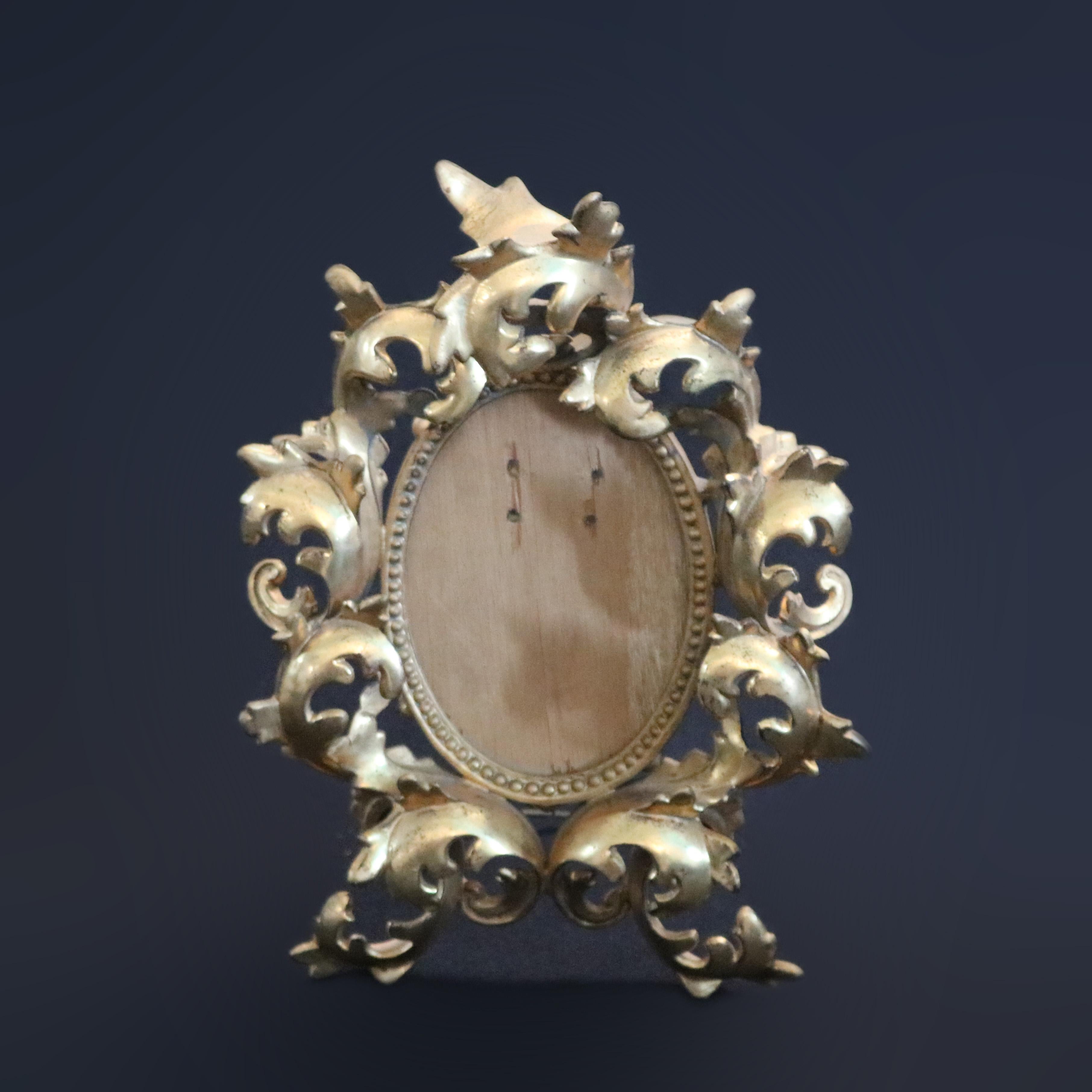 An antique Italian tabletop picture frame offers gilt cast metal foliate form frame with beaded bordering and easel back, circa 1890

Measures: 11.38