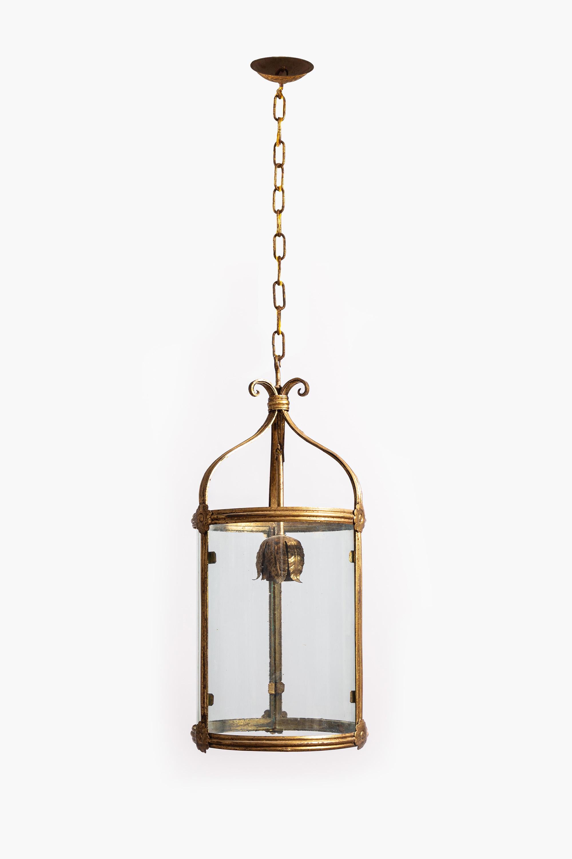 Lanterna italiana in toleware dorato dei primi del Novecento.

Lanterna scultorea in toleware dorato con un portalampada decorativo a foglie d'acanto sospeso all'interno.  Conserva i pannelli di vetro curvo originali realizzati a mano. Appeso con