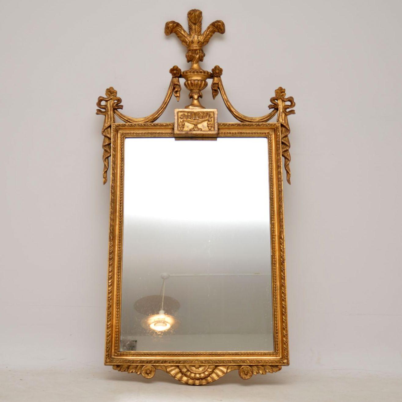 Antique Italian carved giltwood mirror in excellent original condition and dating from circa 1920s period. The giltwood frame has many lovely classical features, including the ‘Prince of Wales Feathers’ on the top. The mirror glass is also in good