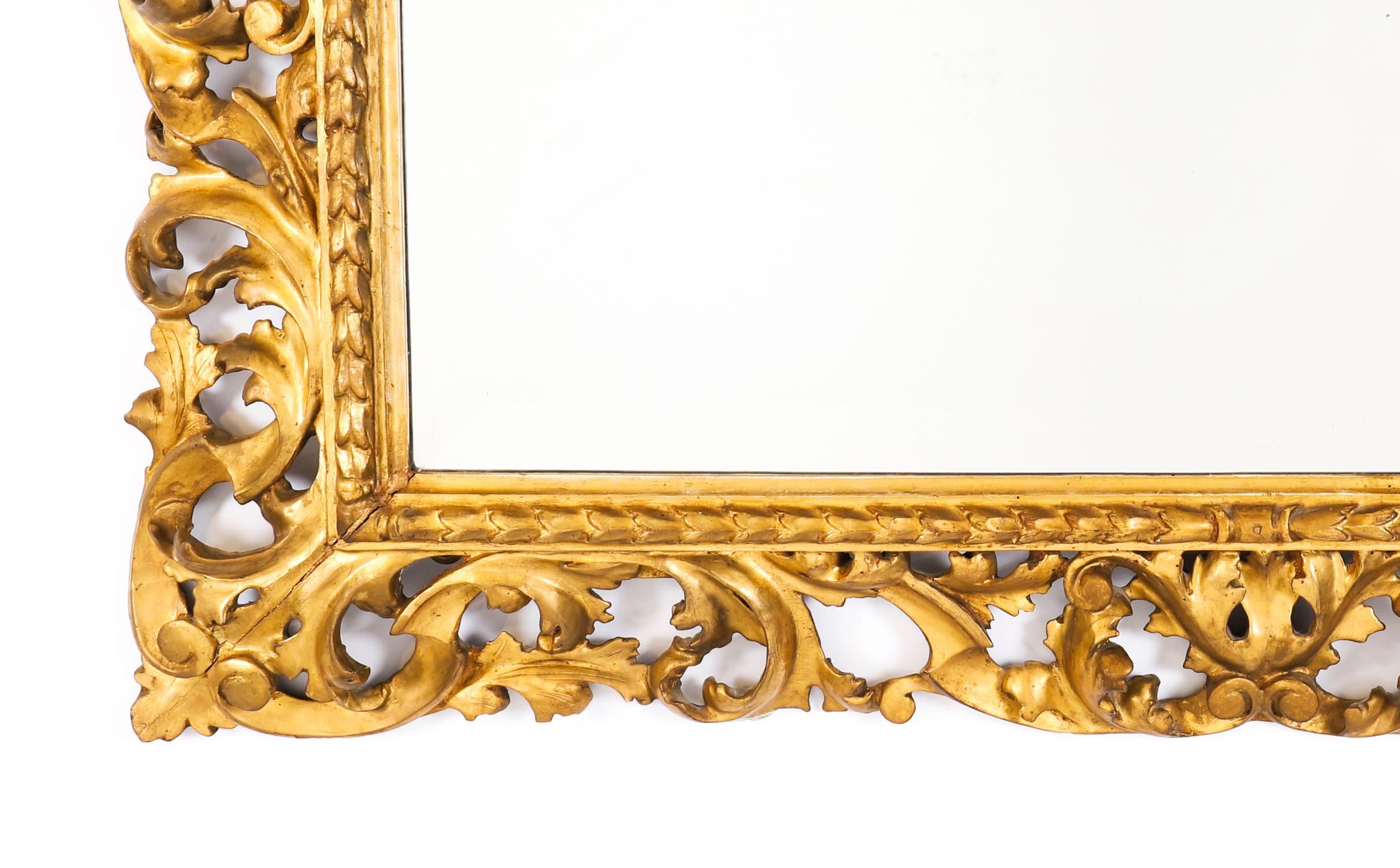 Superbe miroir mural en bois doré italien de Florentine, datant du début du 19ème siècle.
 
Le miroir rectangulaire se compose d'un cadre en bois doré superbement sculpté à la main, présentant un décor de feuilles d'acanthe enroulées en haut-relief