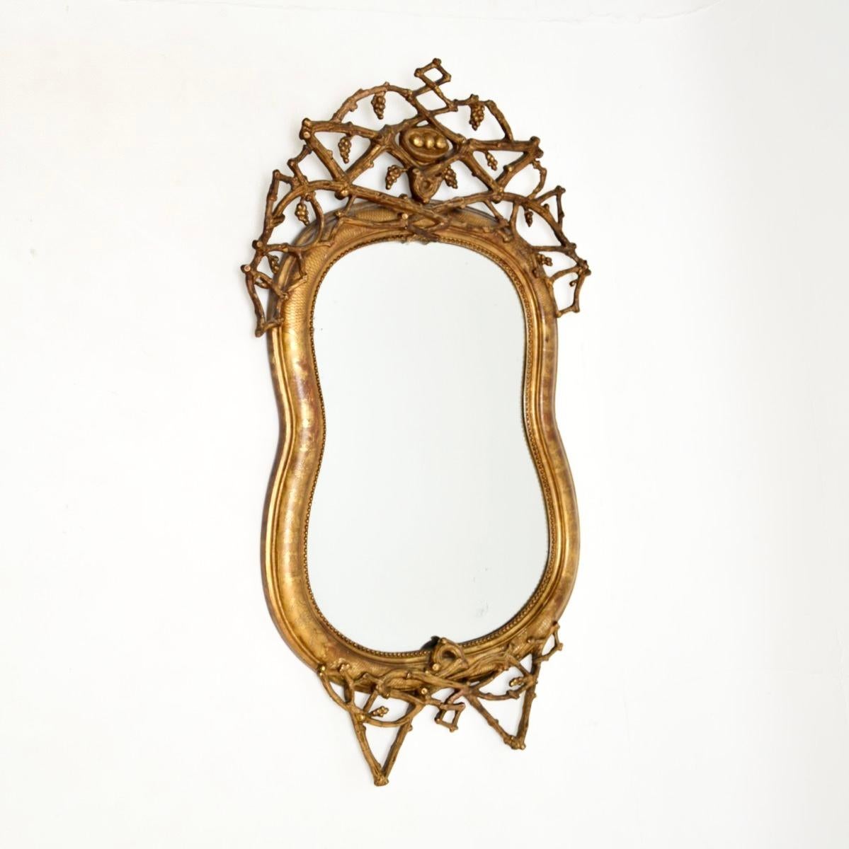 An absolutely stunning antique Italian gilt wood mirror, dating from around the 1860-1880 period.

It is of superb quality and has a gorgeous and quite unusual design. It is mostly solid wood, with decorative gesso mounts in the form of branches and