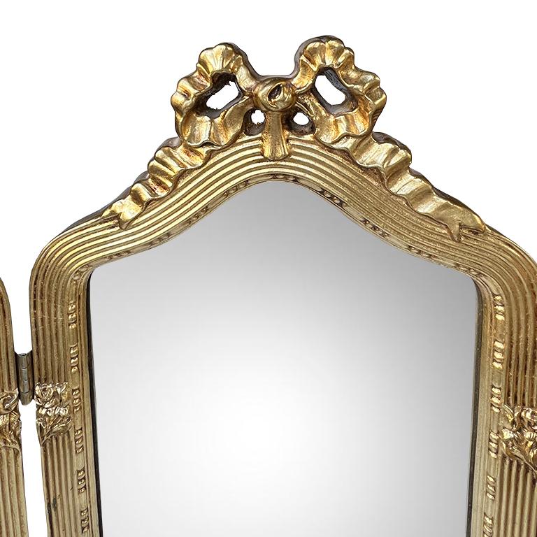 Elevate your space with this exquisite antique Italian tri-fold vanity mirror, a true statement piece for lovers of Hollywood Regency, Rococo Revival, and European antique décor. Crafted in Italy circa early-to-mid 20th century, this giltwood mirror