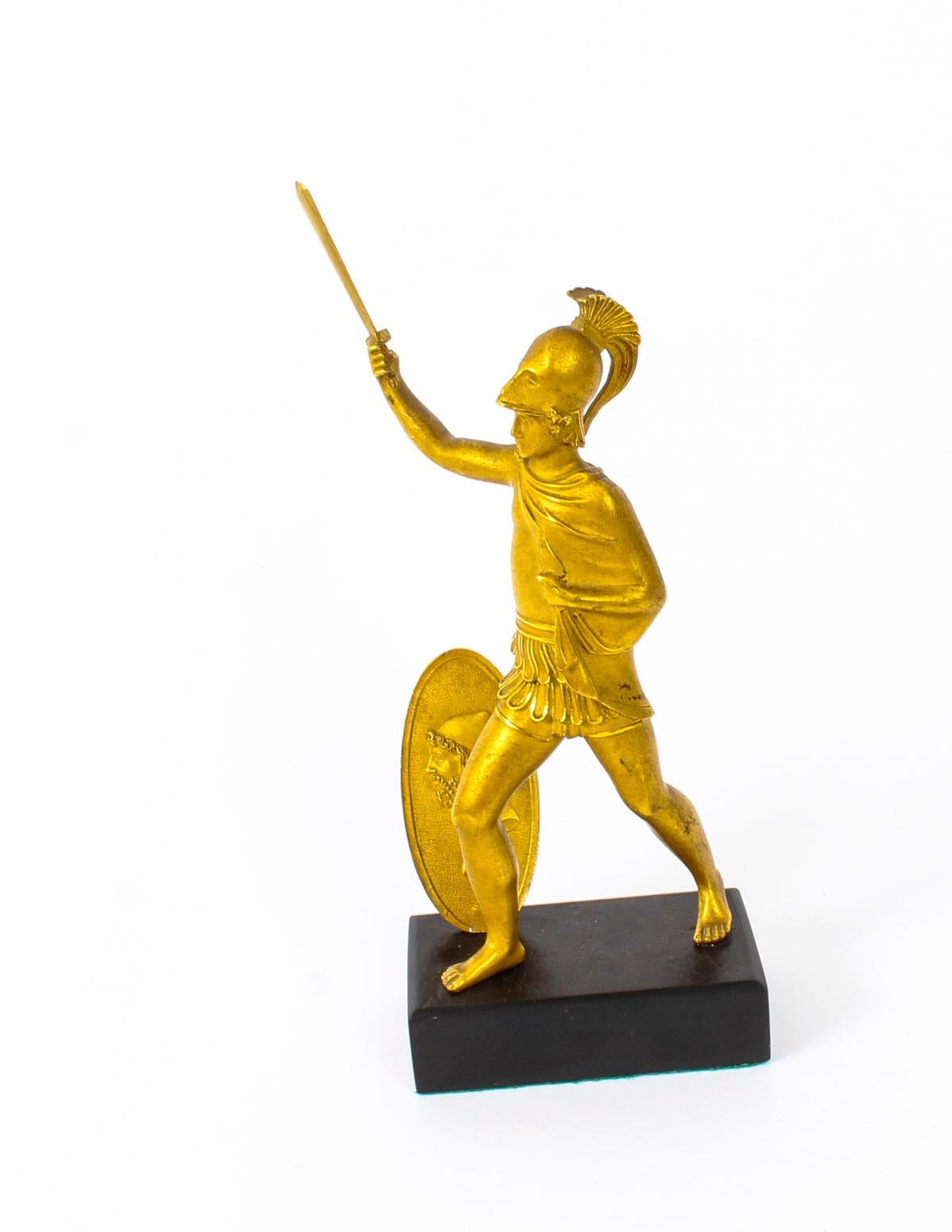 A superbly cast antique Italian Grand Tour ormolu figure of a Roman soldier, circa 1850 in date.
 
The soldier is armed with a raised sword, dressed in traditional costume with a fine portrait shield at his side and stands on a rectangular belge